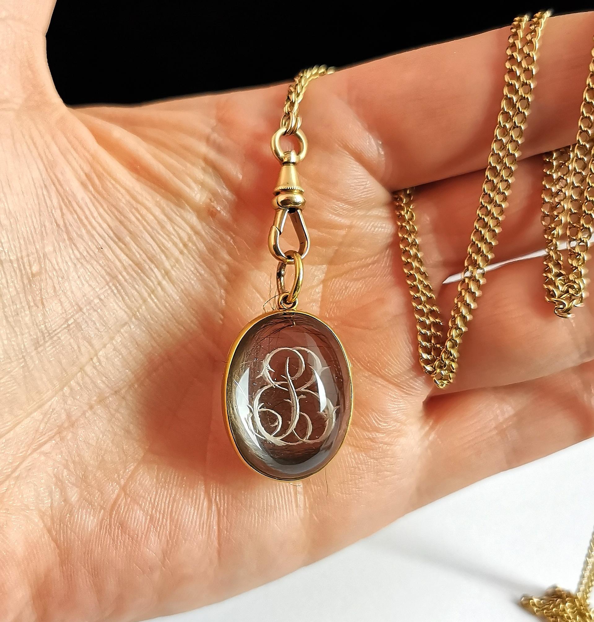 A stunning, rare and important antique, pools of light rock crystal locket pendant.

Beautiful high polished smooth rock crystal cabochons each set into a rich 15kt yellow gold frame, the front of the locket has a hand engraved fancy letter B.

This