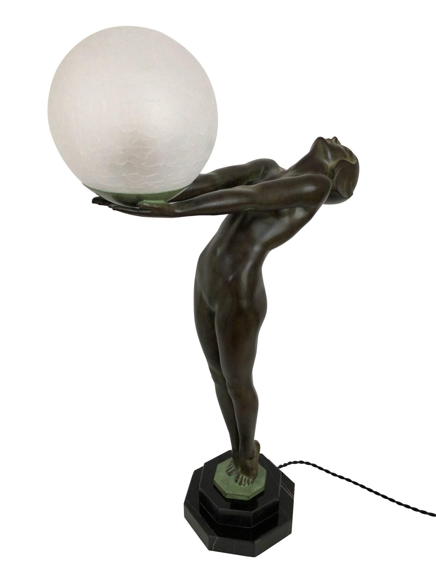 Small model of the famous Clarté
Lumina
Original Max Le Verrier
Art Deco Style, France

Lighted sculpture made in Régule (spelter)
Socle in black marble (could have a different marbleization than the picture) 
signed
Green