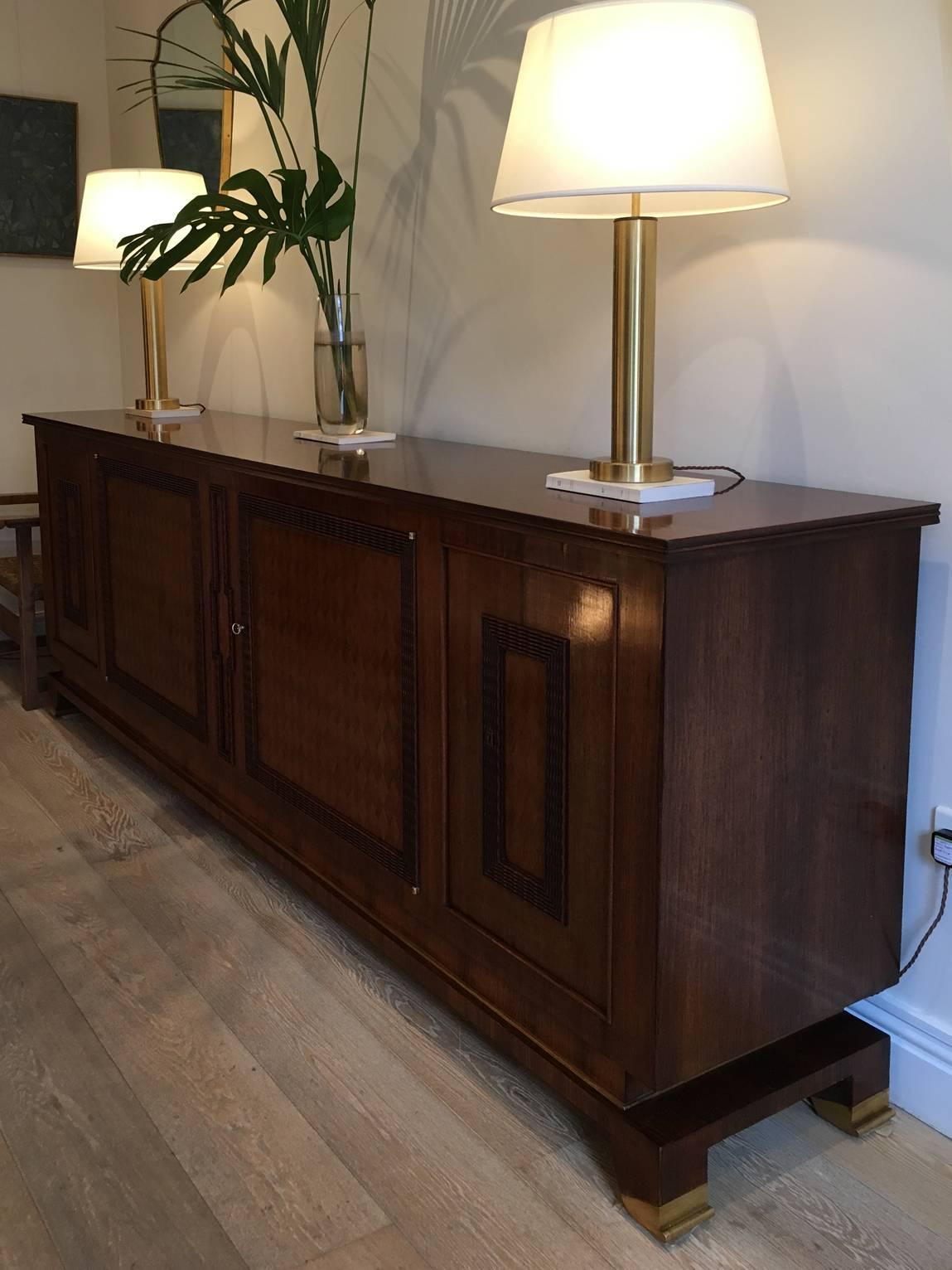 An important Art Deco sideboard by Jules Leleu (1883-1961)
The entire piece veneered in rosewood of superb colour, resting on sabre legs terminating in bronze scrolling end sabot feet, the base with a long bronze line to its front and sides, the