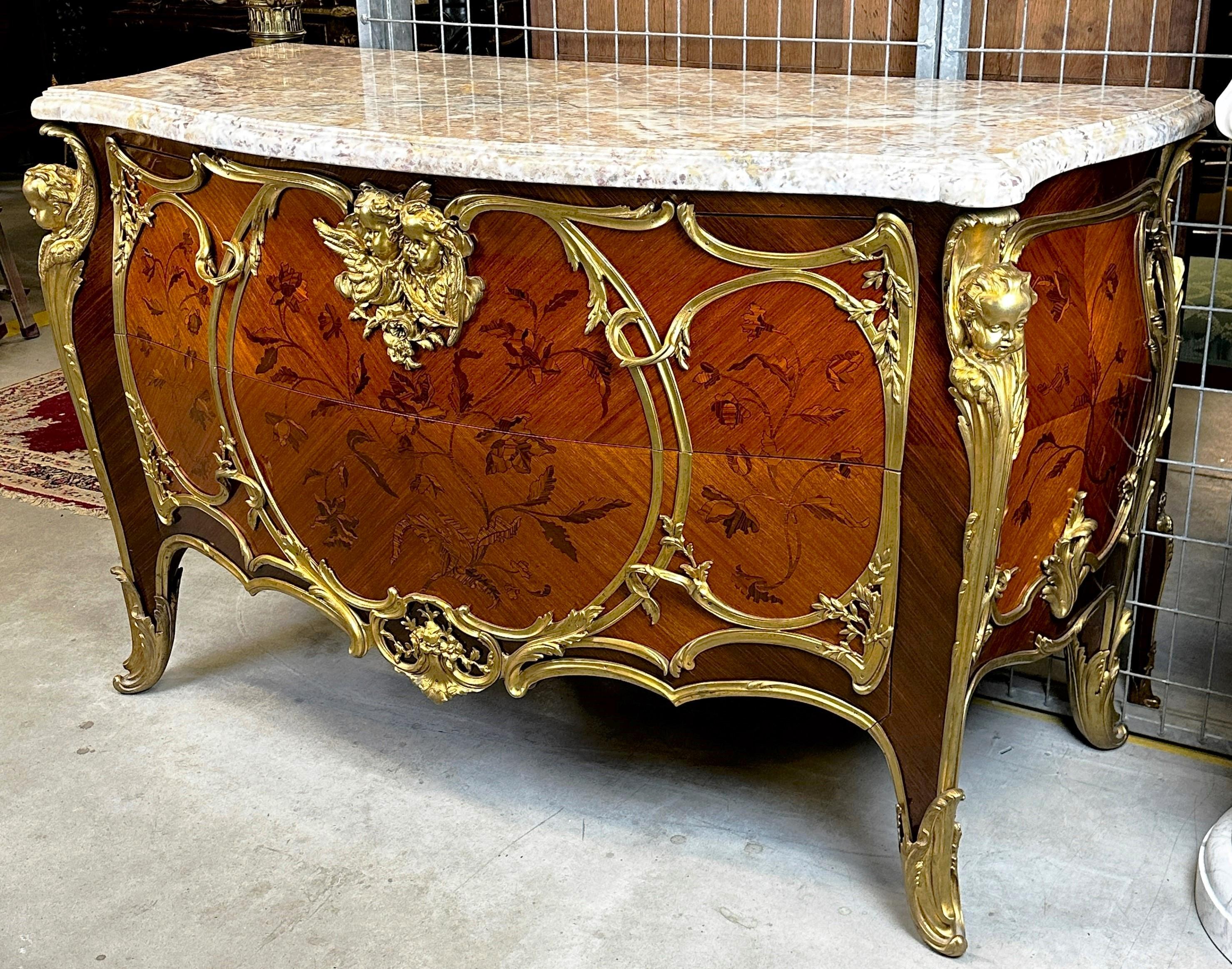 An impressive Louis XVI style chest of drawers, made at the turn of the 19th and 20th century in France. The furniture is characterized by rich gilded bronze decorations. In the corners, under the top, there are figures of charming cherubs, in a