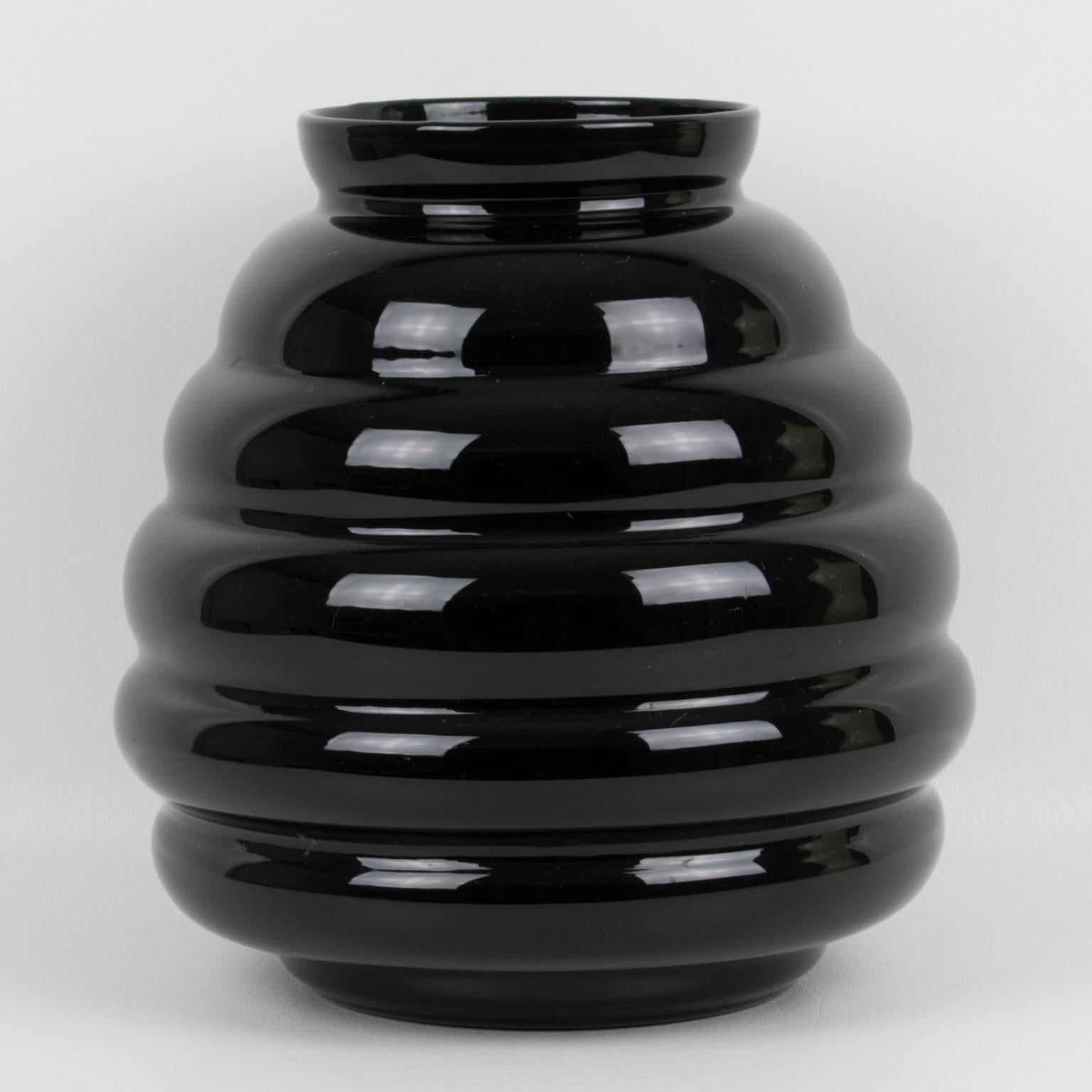 This stunning black opaline glass vase was hand-crafted in Belgium in the 1950s. The massive, rounded design boasts a gadroon shape. The piece is marked underside: Ver Extra Fort - importé de Belgique (Extra-Strong Glass - Imported from