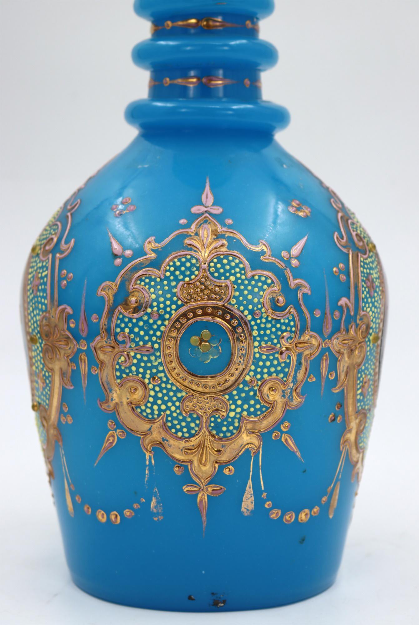 Important Blue Opaline Carafe decorated with enamels and hand painting of the ?hah of Iran, 19th century, Near East.
Measures: H: 55 cm, D: 18 cm.