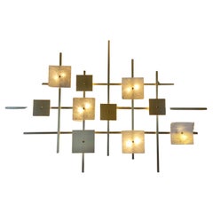 Important brass and marble wall light in the style of Eric de Dormael 1990
