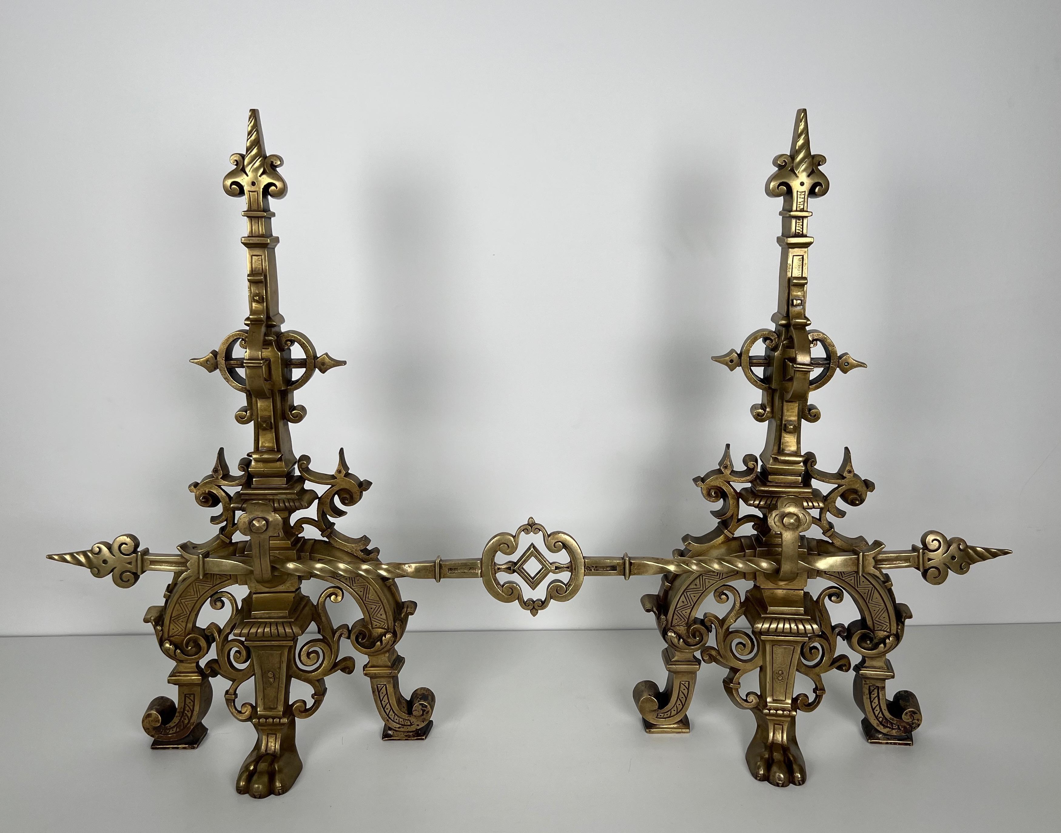 This rare and important bronze fireplace set is composed of a pair of richly decorated bronze andirons and of a central bar connecting the 2 andirons. This is a French Renaissance style work. 19th century