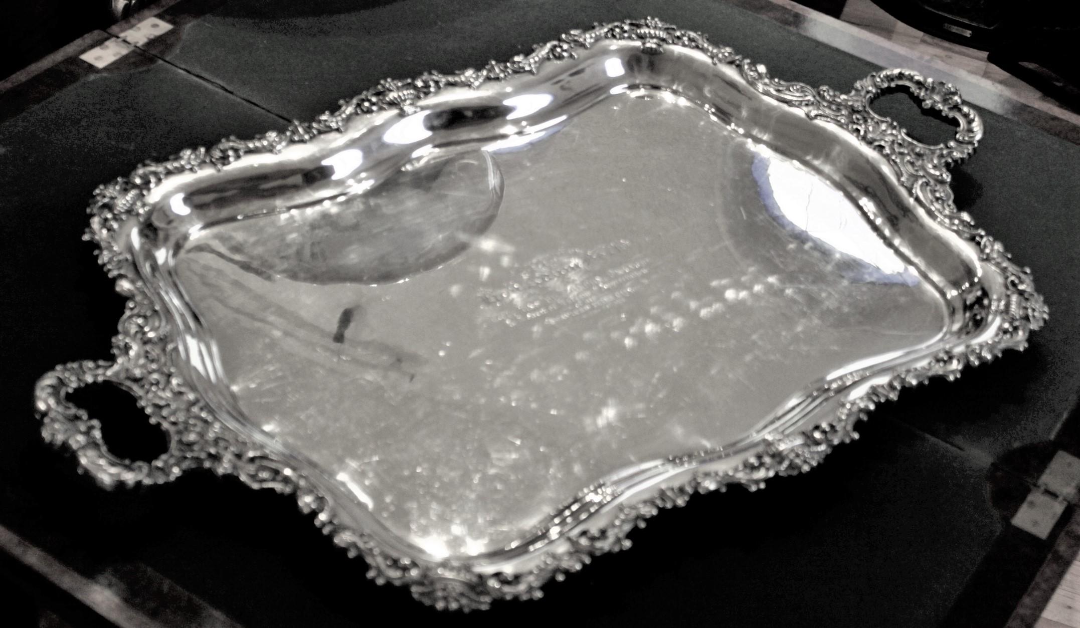 This very large and substantial sterling silver serving tray was made by Meridian Silver Company of Canada in circa 1914 in a Rococo Revival style. This tray was presented to the Hon. Adam Beck by the City of London, Ontario Canada for his 