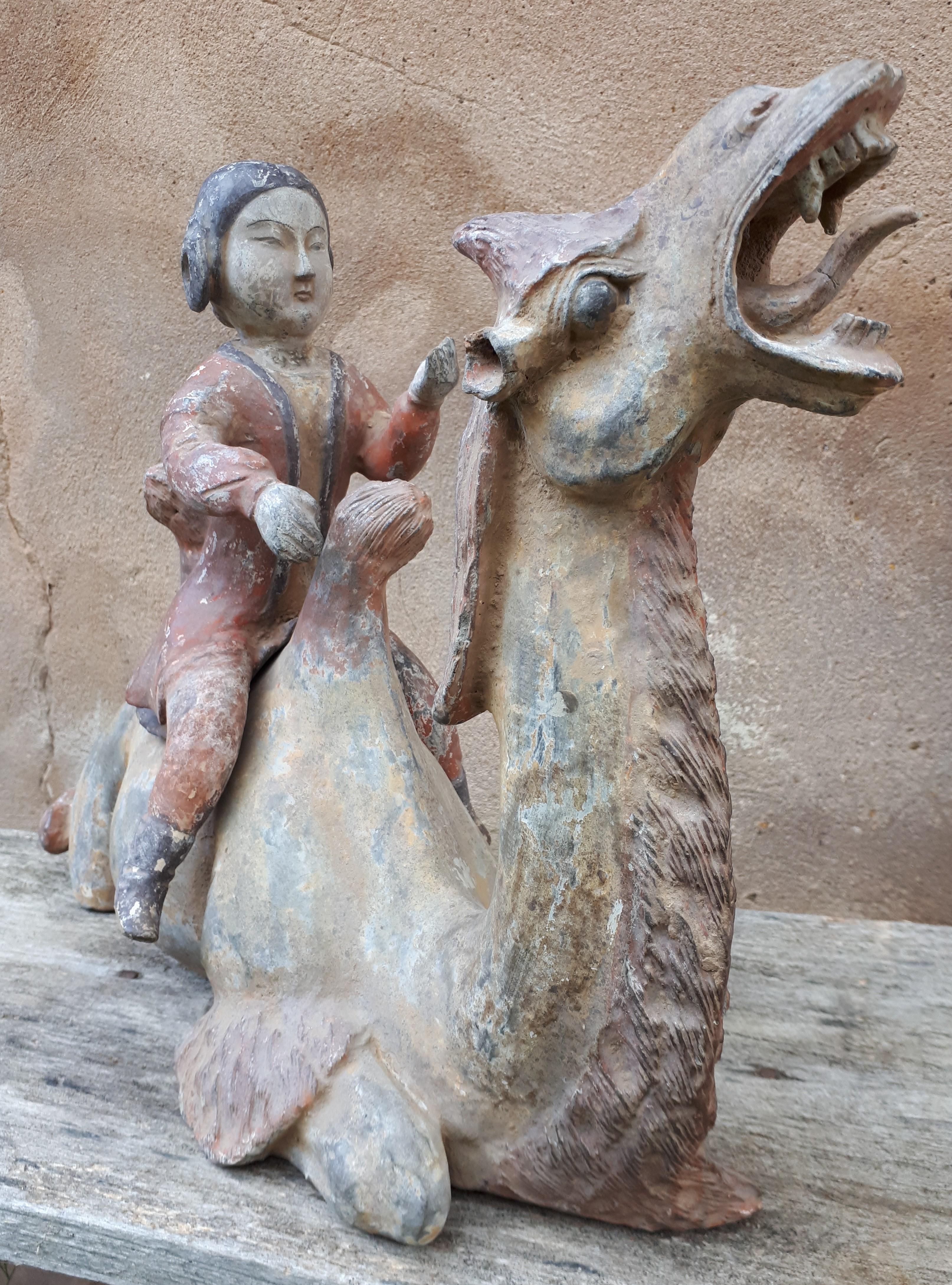 Mingqi in grey terracotta with white slip and polychromy, representing a Bactrian camel, ridden by a court lady.
Good condition.
Please note that all ancient Chinese terracotta sculptures were placed in the graves of the deceased to accompany them