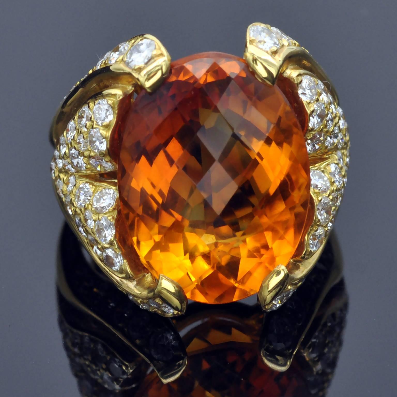 Important cocktail ring. The center citrine is fully facetted, top and bottom, making it sparkle in a fascinating way.  the body of the ring, a diamond set leaf like motif hold the central stone buy the sides only leaving openings to see its beauty.