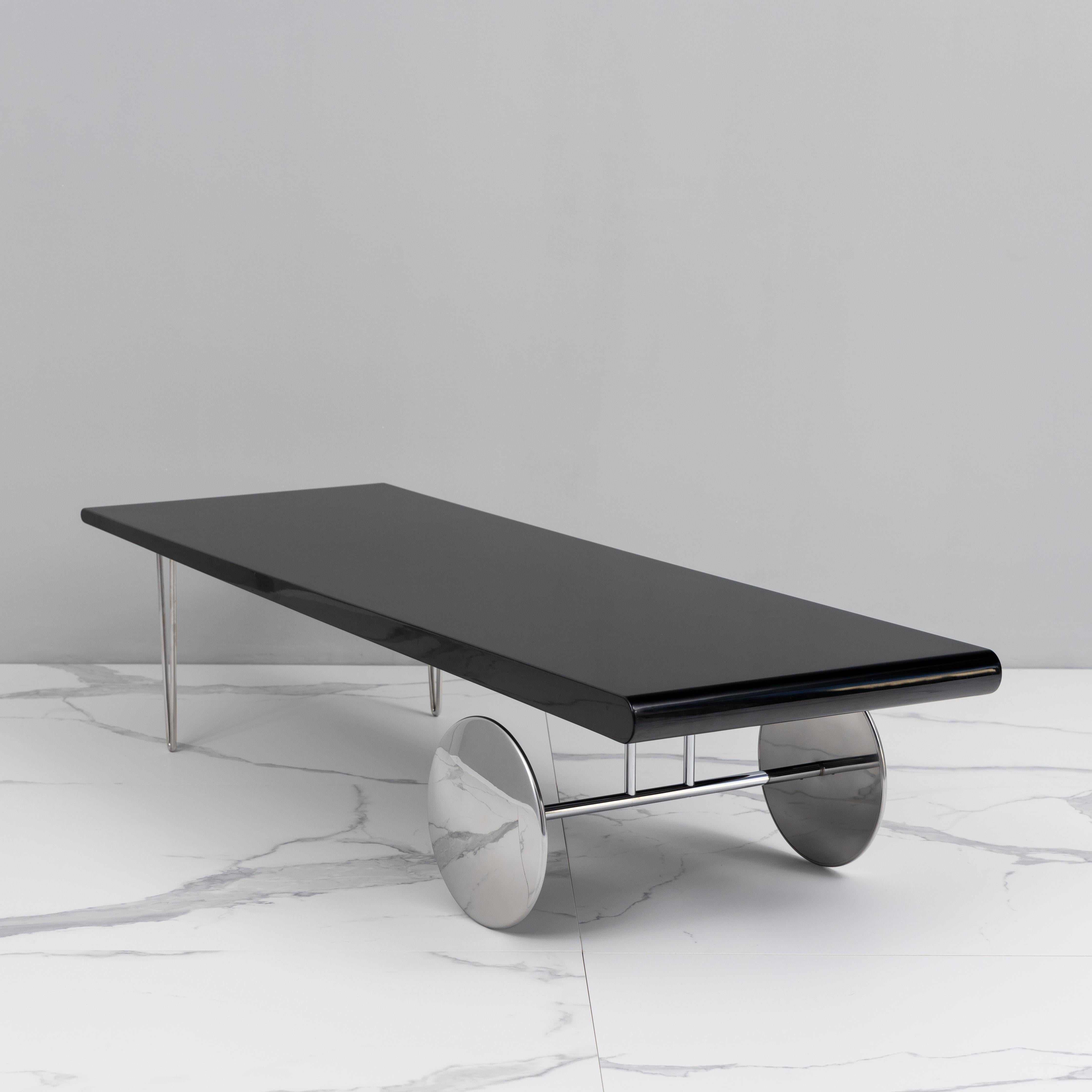 This coffee table was designed by Gilles Derain in 1985. It's a rare piece, part of Lumen Edition. It's made of chromed steel and black lacquered wood MDF. 



