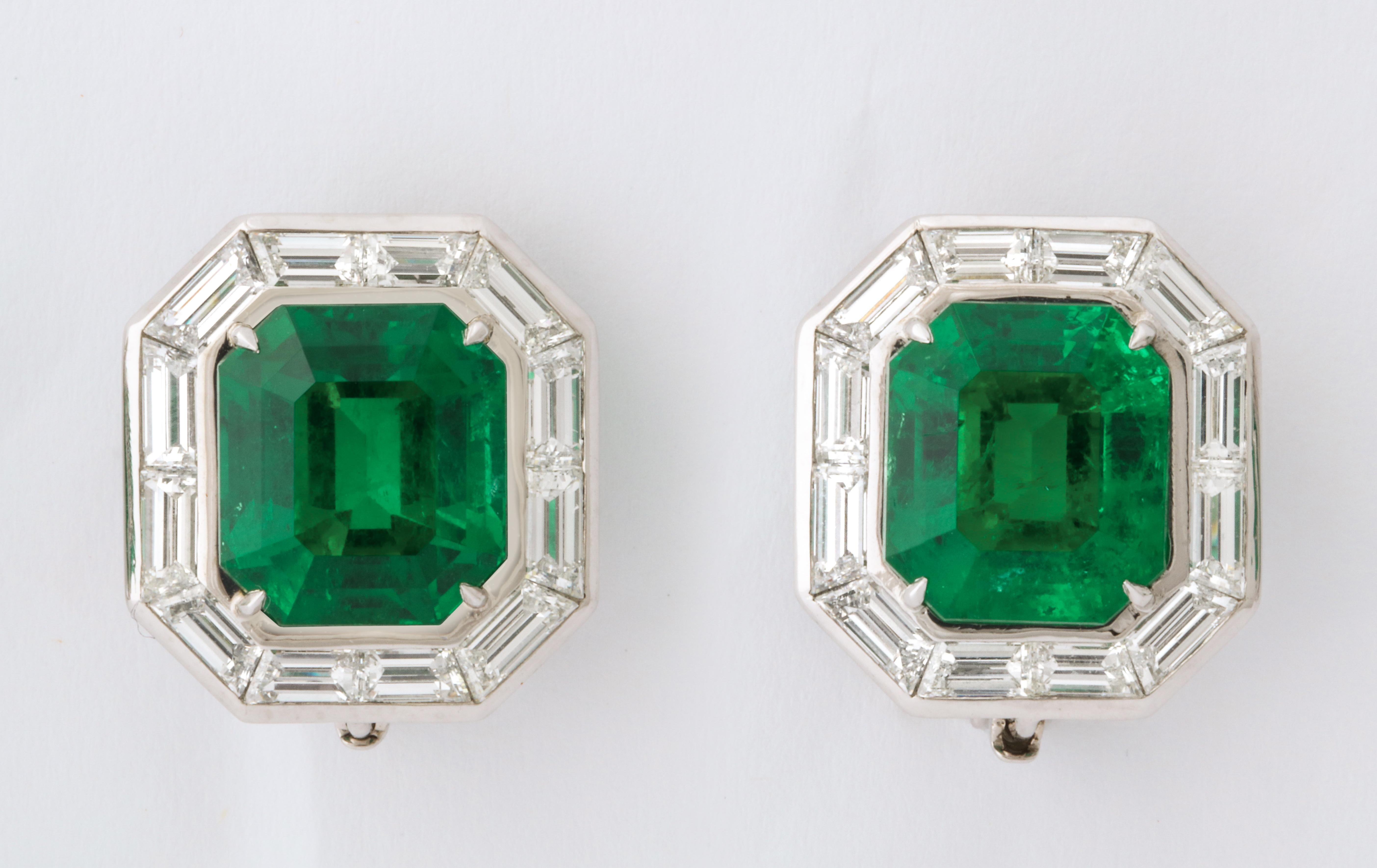 The very fine gem quality Colombian emeralds weighing 5.53cts and 5.58cts are surrounded by custom cut baguette diamonds (24=3.86cts).  The exquisite platinum mounting was completely handmade in one of New York's finest ateliers.  The emeralds are