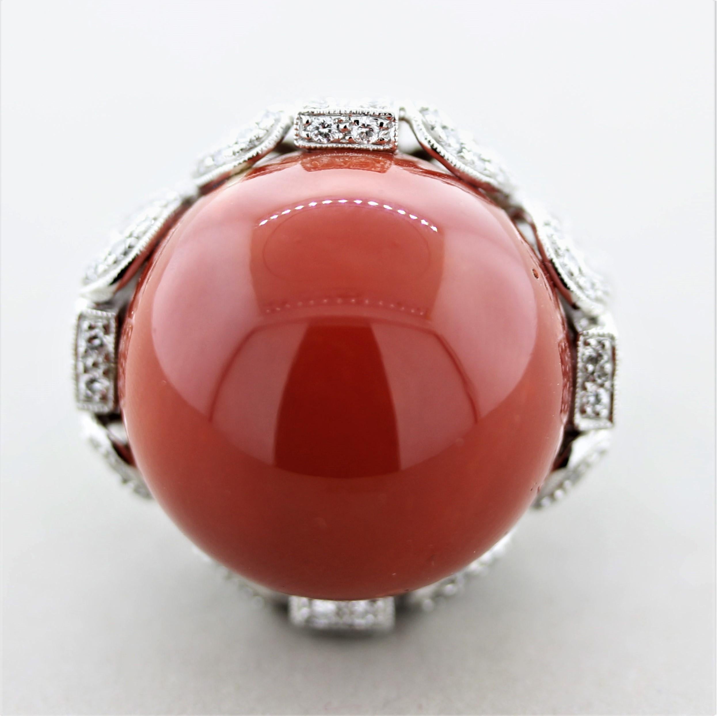 A large and important piece of natural coral is featured in this big and bold ring. The red coral measures 22.3 millimeters which is extremely rare and sought after. It takes over 50 years for coral to grow this size and unfortunately wild coral