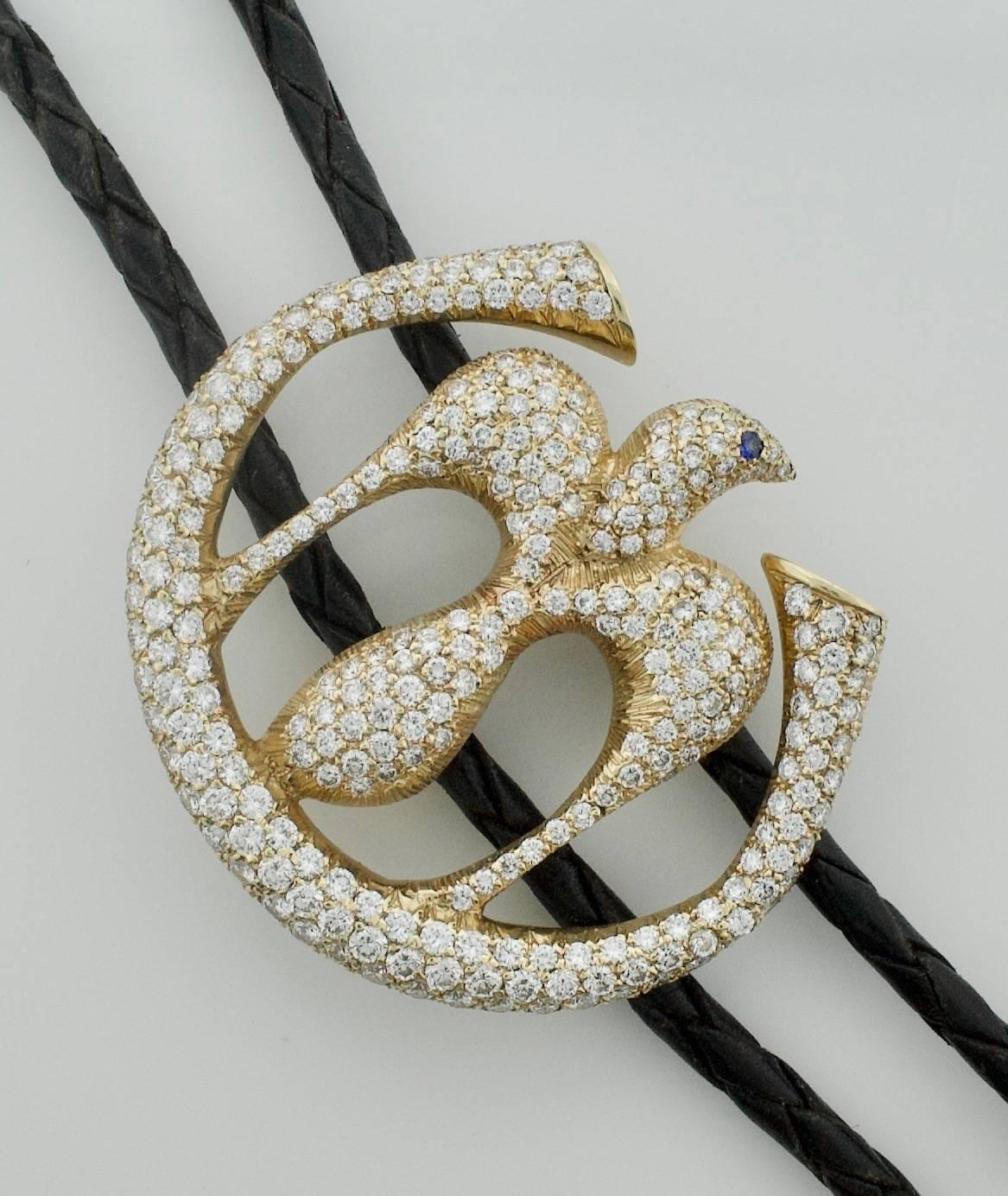 Important Diamond Bolo Tie in 18k Yellow Gold
Two Hundred and Seventy Nine Round Brilliant Cut Diamonds weighing 6.00 carats approximately
Even The Tips are 18k Gold
Depicting a Dove set inside a 