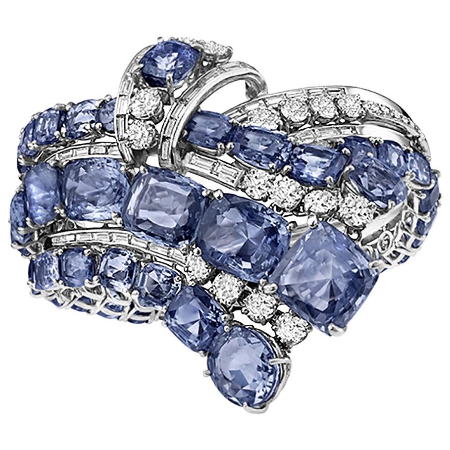 An important platinum cuff bracelet with cascade forms, jeweled by approximately 130cts of natural blue Ceylon sapphires and 10cts diamonds. Mounted on platinum. Circa 1950