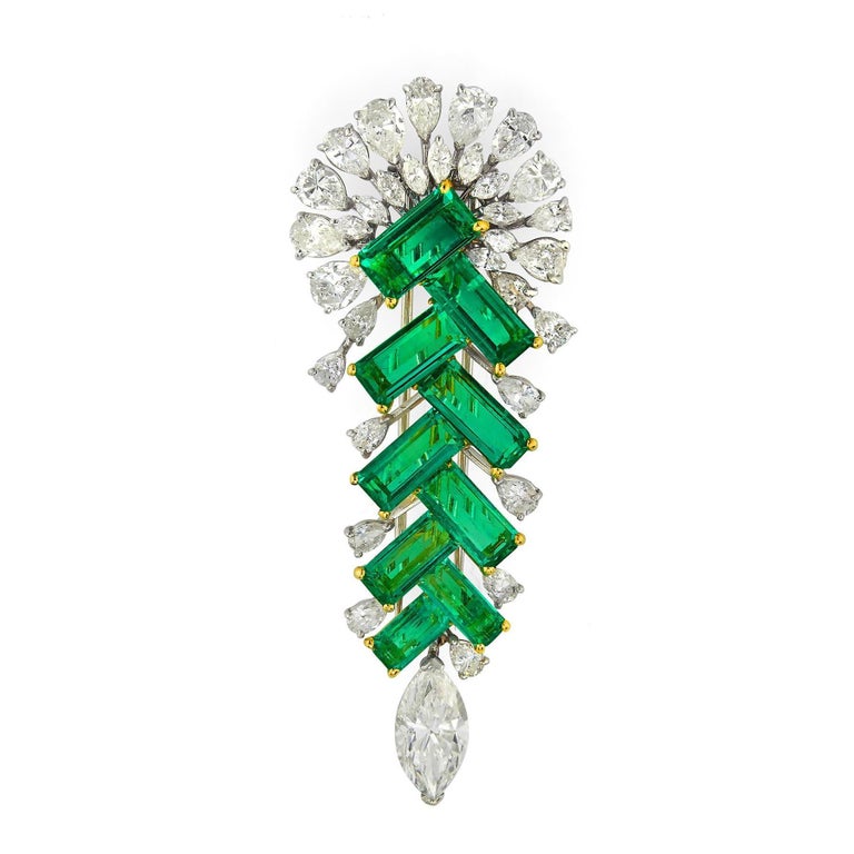 Emerald & Diamond Brooch

9 matching emerald cut emeralds surrounded by pear & marquise cut diamonds set in platinum & 18k white gold 

Measurements: 2.50