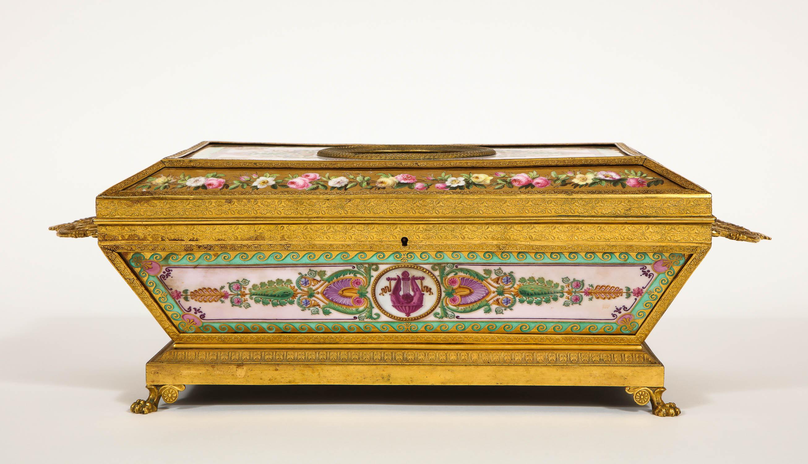 An Important and very rare Empire period Paris porcelain ormolu-mounted Empire rectangular shaped two-handled casket decorated and assembled by Feuillet or Sèvres Porcelain manufactures. The cover inset with a simulated hard stone cameo of Ceres in