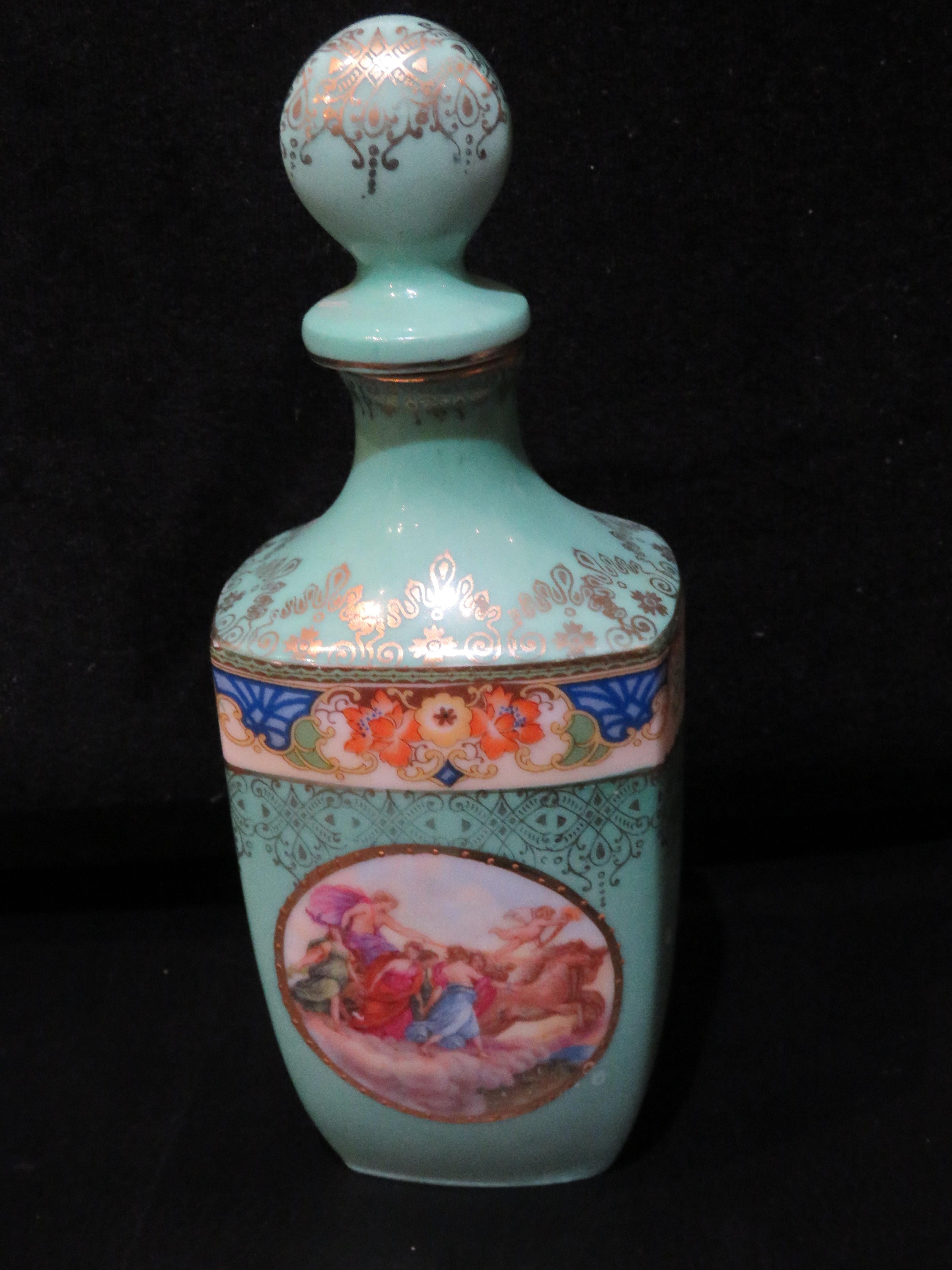 The Following Item we are offering is This beautiful antique bottle features a lovely Neoclassical Scene. The vase is painted a Turquoise Green and porcelain has relief details which compliment the lavish gold gilt filigree and stenciled borders.  