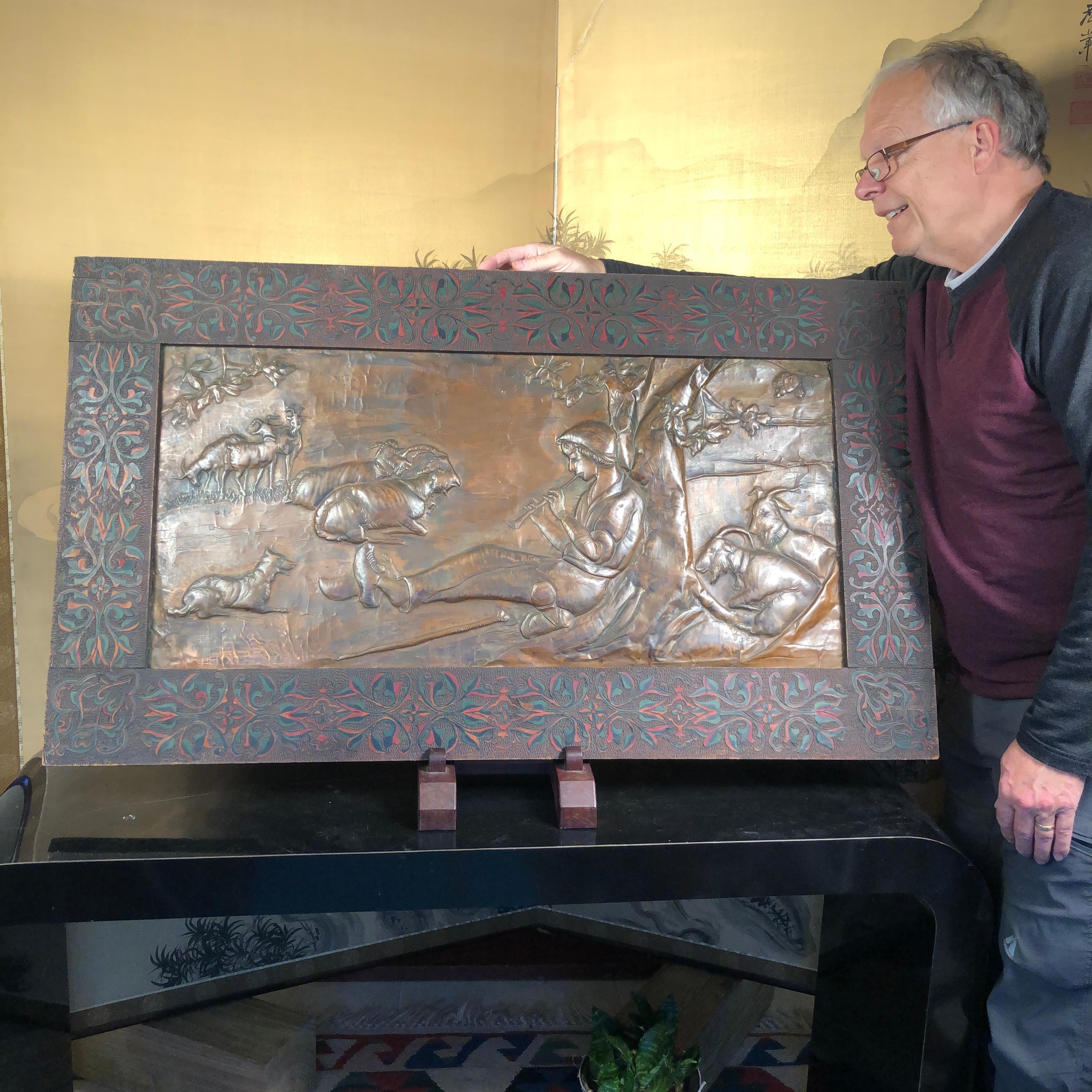 This is an original and beautiful 25 inch by 45 inch hand painted and hand incised wood framed work of art -and containing a wonderful hand hammered copper repousse panel of the iconic Bethlehem Shephard Boy Flute Player. It was created by one of