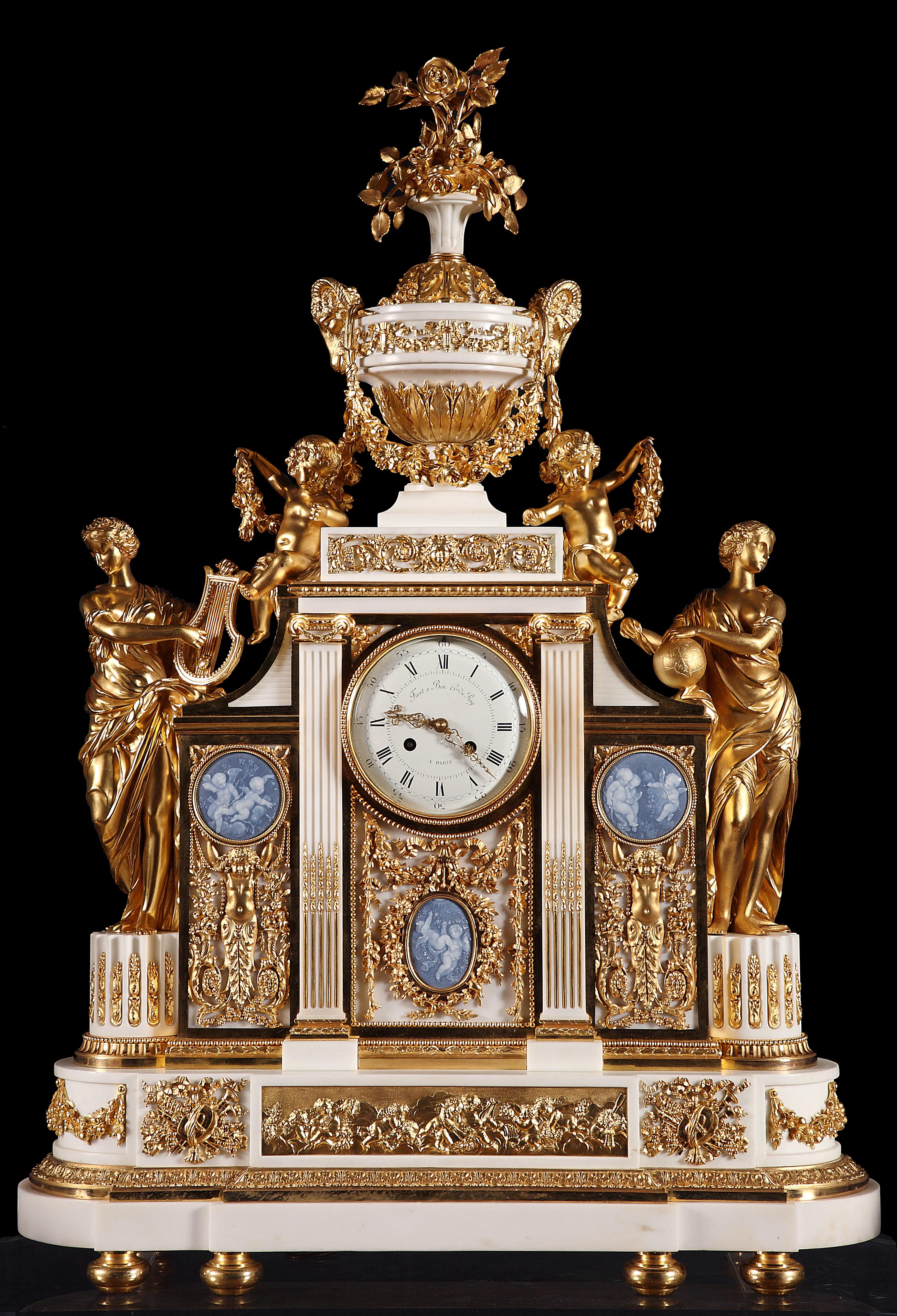 Marked on the dial Furet & Bon, Hrs du Roy, à Paris

Measures: Clock – Height 98 cm (38 1/2 in.), width 70 cm (27 1/2 in.), depth 25 cm (9 3/4 in.)
Candelabra – Height 116 cm (45 2/3 in.) & 92 cm (36 1/4 in.), diameter 50 cm (19 2/3