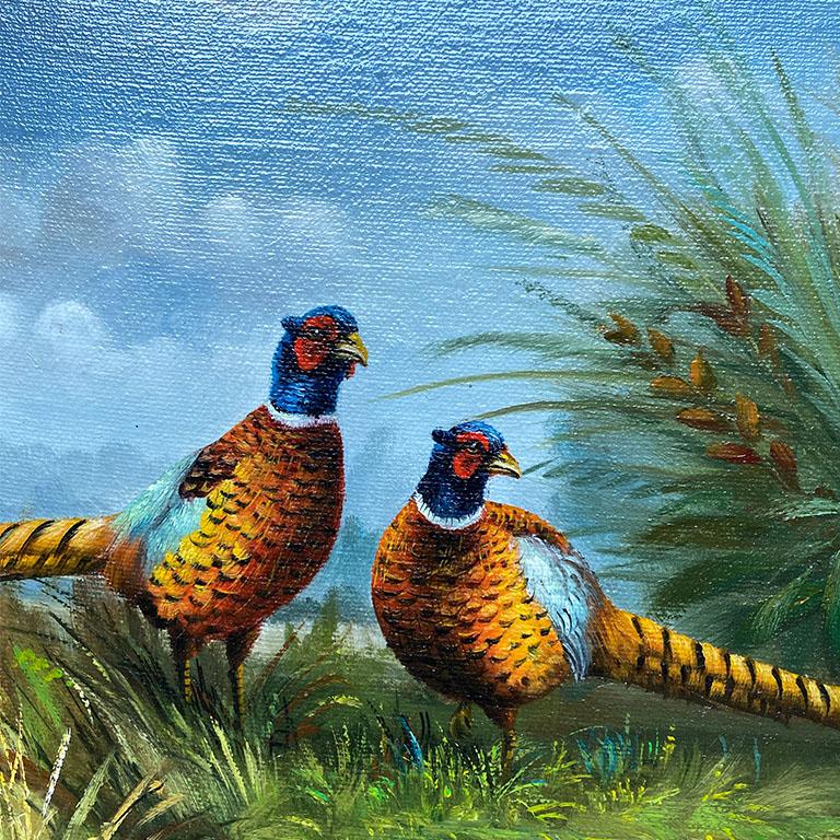 A gorgeous framed rectangular pheasant painting on canvas. This masterpiece depicts a pair of pheasants grazing in a sea of bright green foliage. Each bird has an orange stripe body, with blue feathers, a long tail, and a blueish head with a ring of