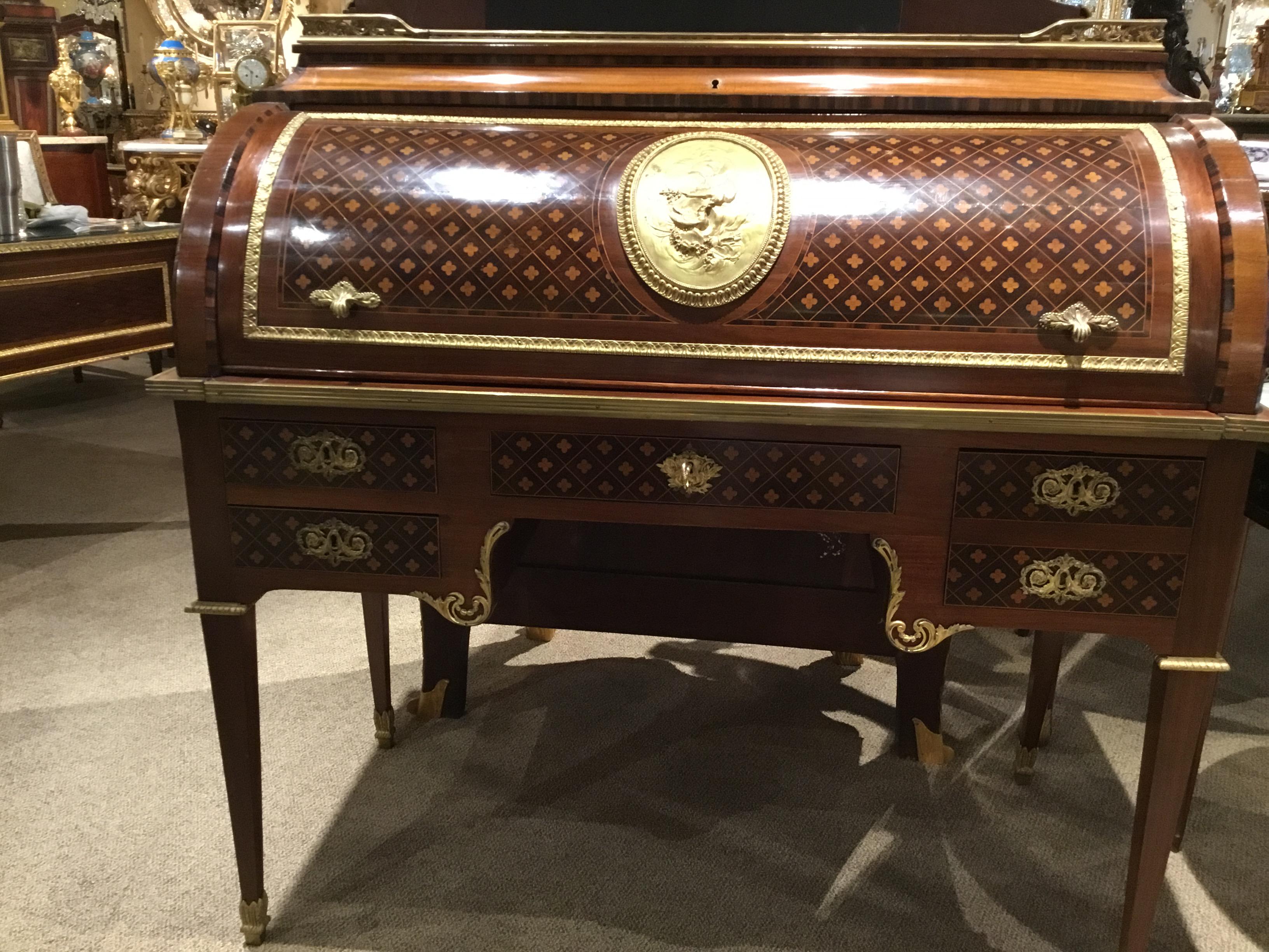 Antique French marquetry and parquetry bureau a cylindre
After Francois Linke. This secretaire a cylindre is in the
Louis XVI style. The top has a gallery along the back and sides.
The roll top is inlaid with kingwood, walnut and tulipwood and