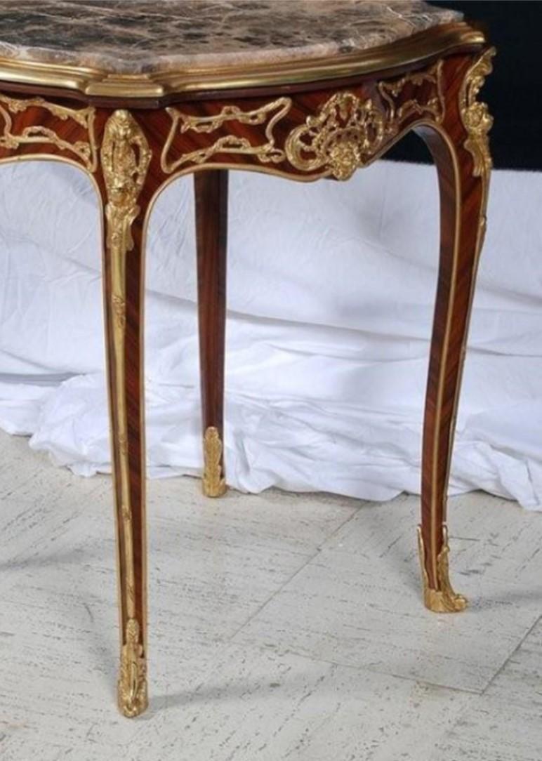 The Following Items we are Offering is A Rare Pair of Magnificent European Louis XV Style Mahagony and Bronze Ormolu Mounted Carved Ormolu Mounted Wooden Marble Top End Tables. Tables are intricately detailed with Bronze Cherub Mounts and Ornately