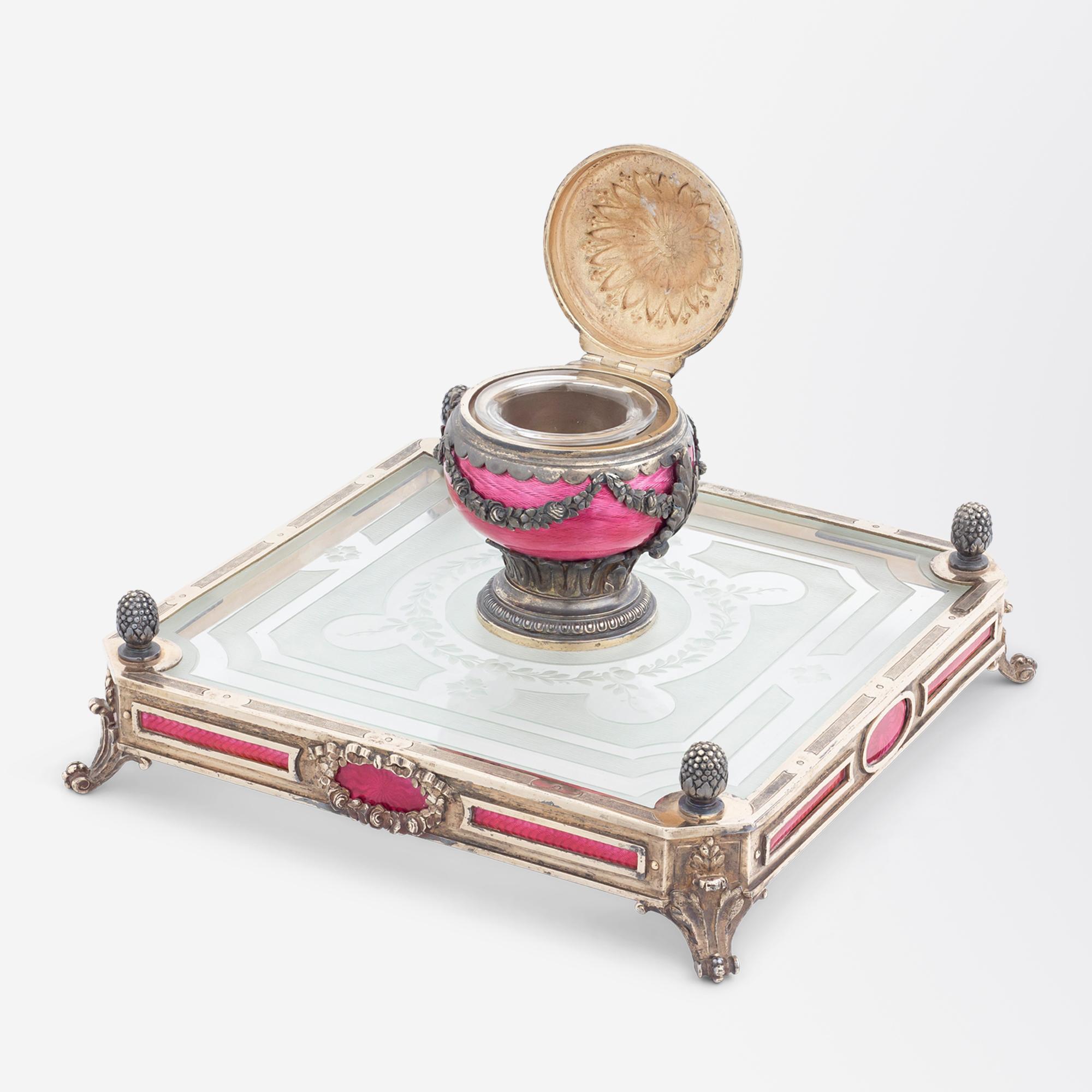 This inkwell is one of the finest examples we have had in our collection to date. Crafted by the firm 'Dreyfous' the inkwell is made from .800 purity silver, etched crystal and cranberry guilloche enamel. The square form crystal base which sits upon