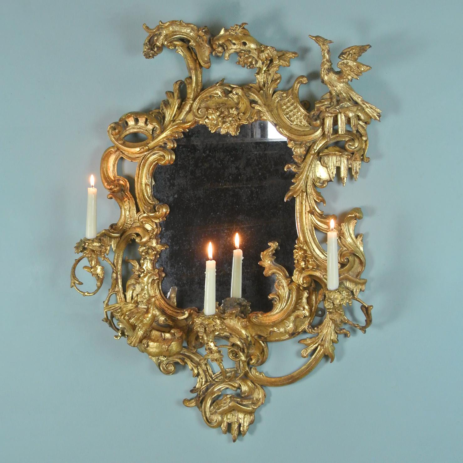 An extraordinary Mid-18th Century three branch girondole mirror with original gilding in the manner of Thomas Chippendale and combining both Gothic and chinoiserie elements to create a ‘fantasy’ landscape. 

The frame superbly carved and a
