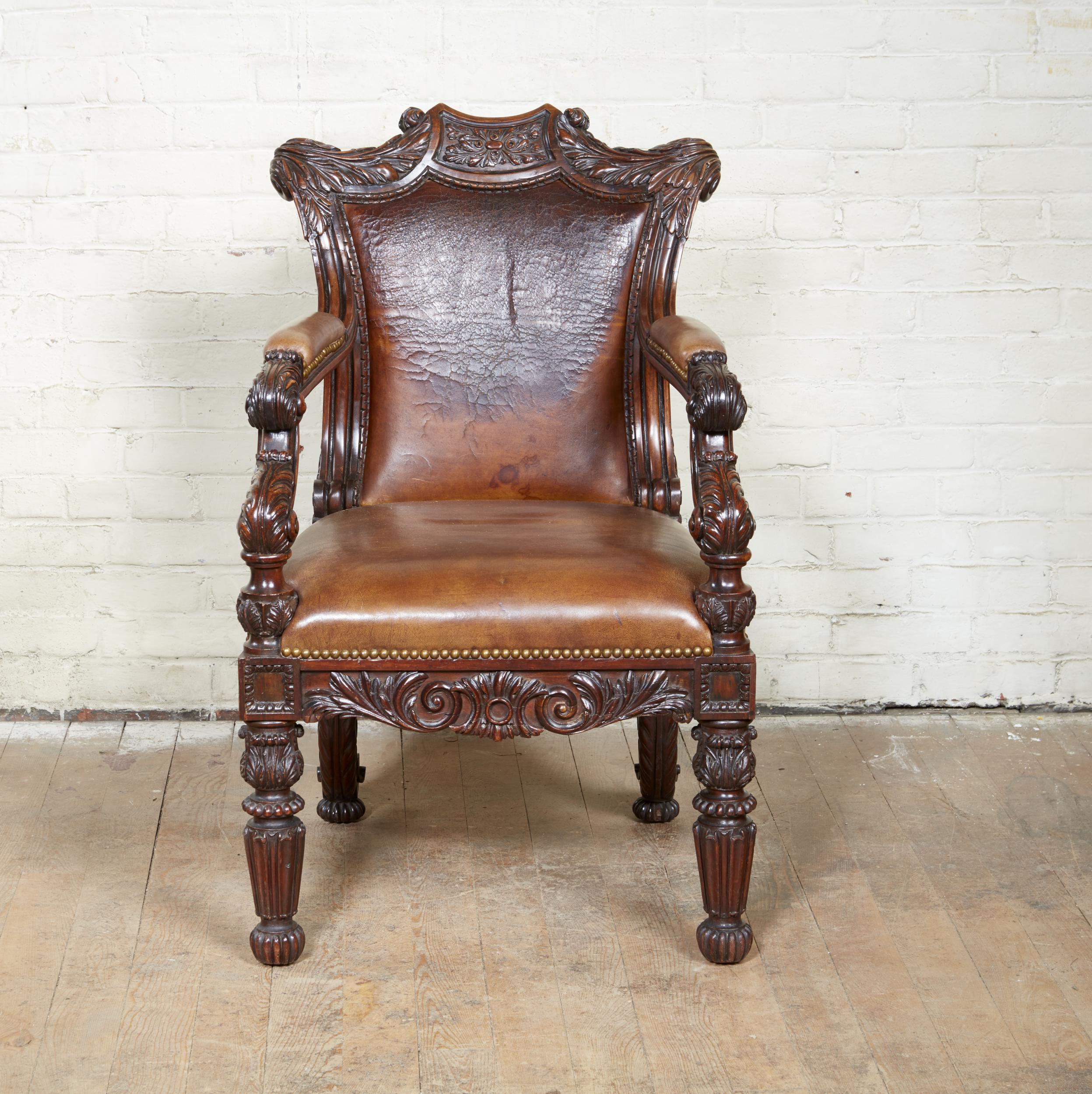 Important and very fine George IV carved rosewood armchair, probably by Gillows of Lancaster and London, of great scale and profusely carved in the Grecian style with boldly scrolled and acanthus leaf carved ears flanking a squared paterae, with