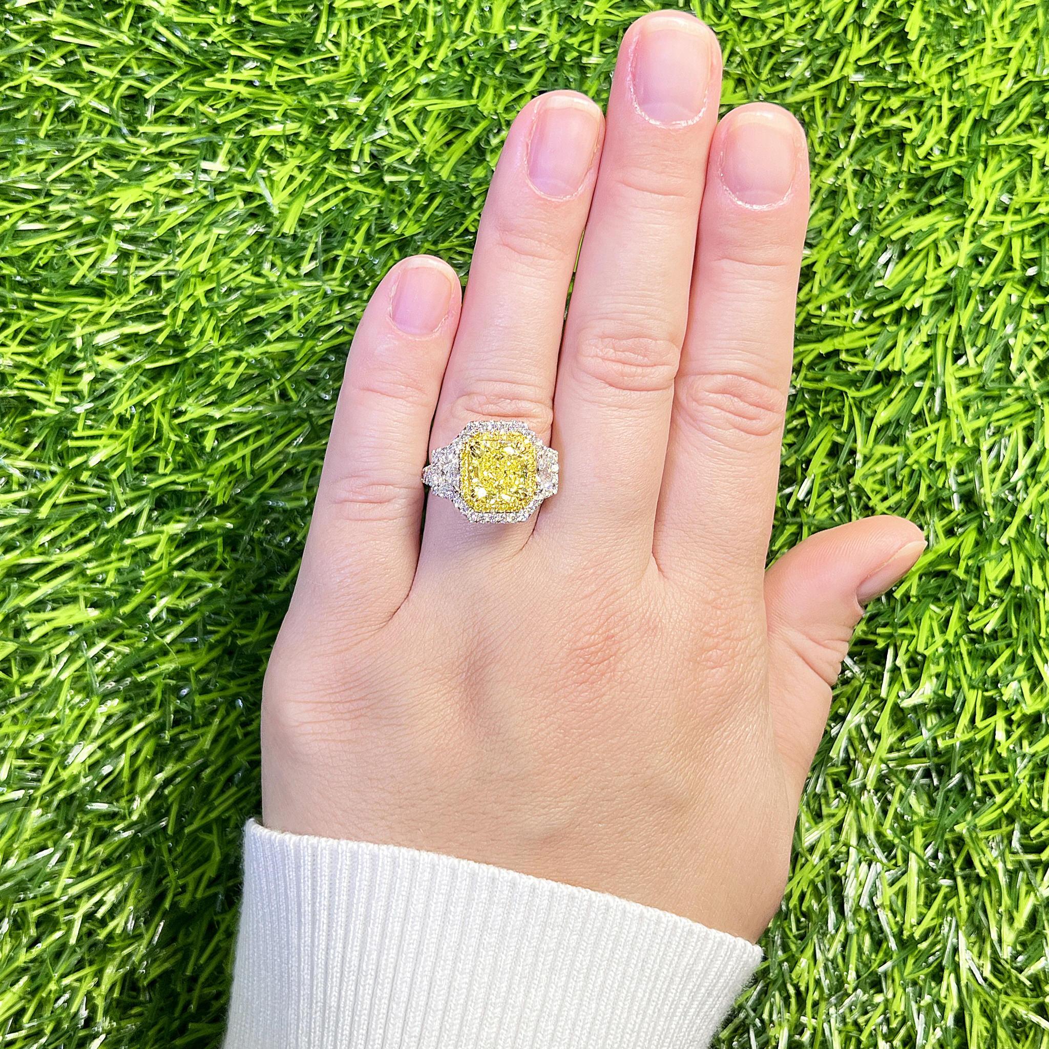 It comes with the GIA Laboratory Certificate
GIA Certified Natural Fancy Light Yellow Diamond = 3.52 Carat
Cut: Radiant, Clarity: VS1
30 Fancy Yellow Diamonds = 0.17 Carats
2 Trapezoid Diamonds = 0.67 Carats
62 Round Diamonds = 0.87 Carats
All