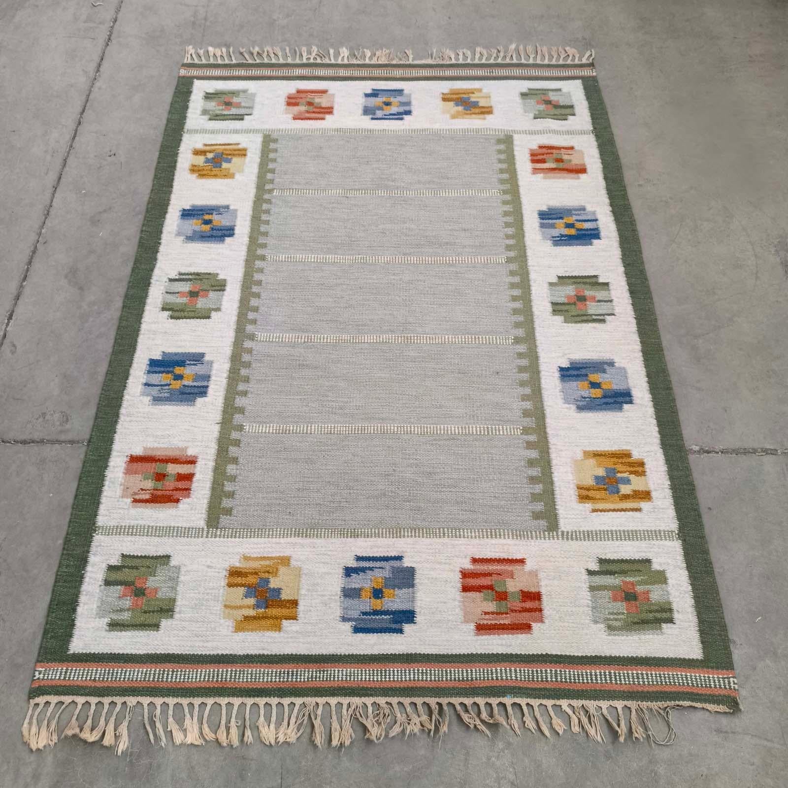 Rug & Kilim Kilim vintage suédois 'Gripsholm Grön', 140x200cm.
Découvrez la beauté des kilims suédois avec ce vintage en laine tissé à la main.  tapis rollakan. Dotée d'un Design/One biophilique et de couleurs terreuses, cette pièce offre un look