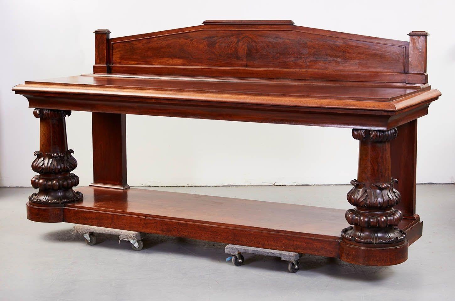 Most impressive George IV period mahogany serving/console table by the leading Dublin firm of Mack, Williams and Gibton, having arched architectural backsplash over richly patinated serving surface with plate rack (where it is conspicuously stamped