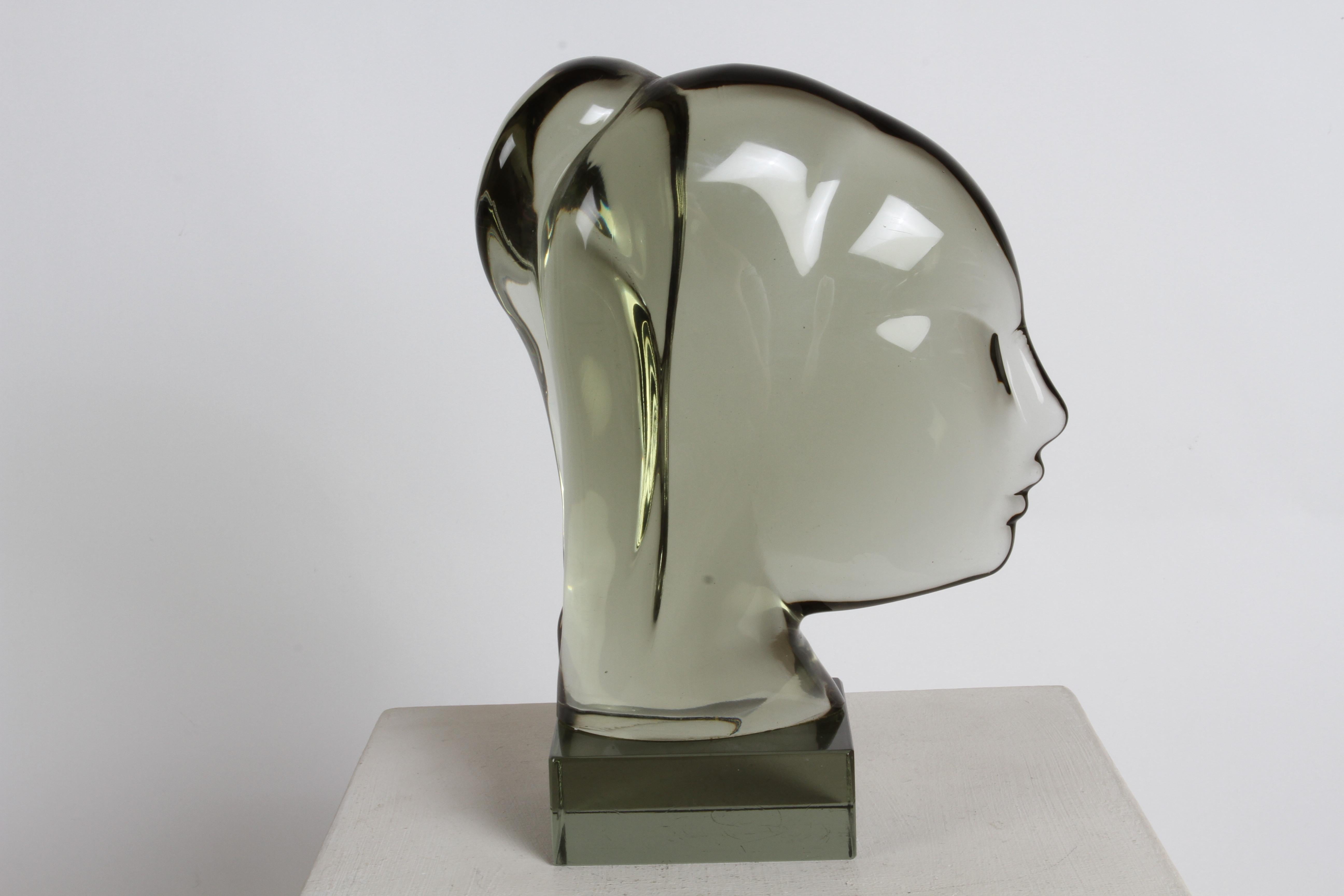 Master Italian Glass Artisan Ermanno Nason (1928-2013) created this smoked glass young female bust with ponytail sculpture in 1975. The only other example I found in my research was in his own gallery /museum, now temporary closed. Some minor