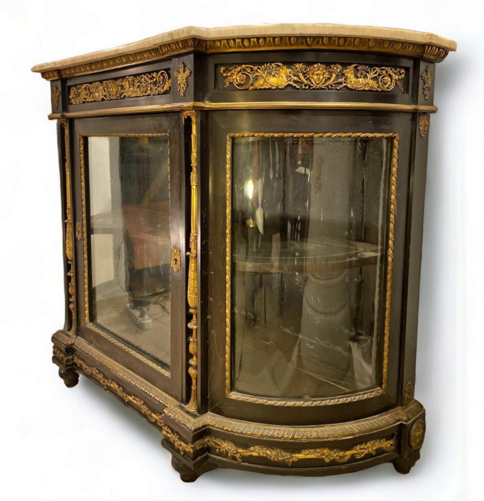 Important Jeune Belfort (1813) Sideboard, France, Napoleon III 19th Century

Sideboard, France, Napoleon III era
101 x 49 x 139cm
with single central glass door. Ebony plated over oak. Gilded and finely chiselled bronze fittings, with white marble