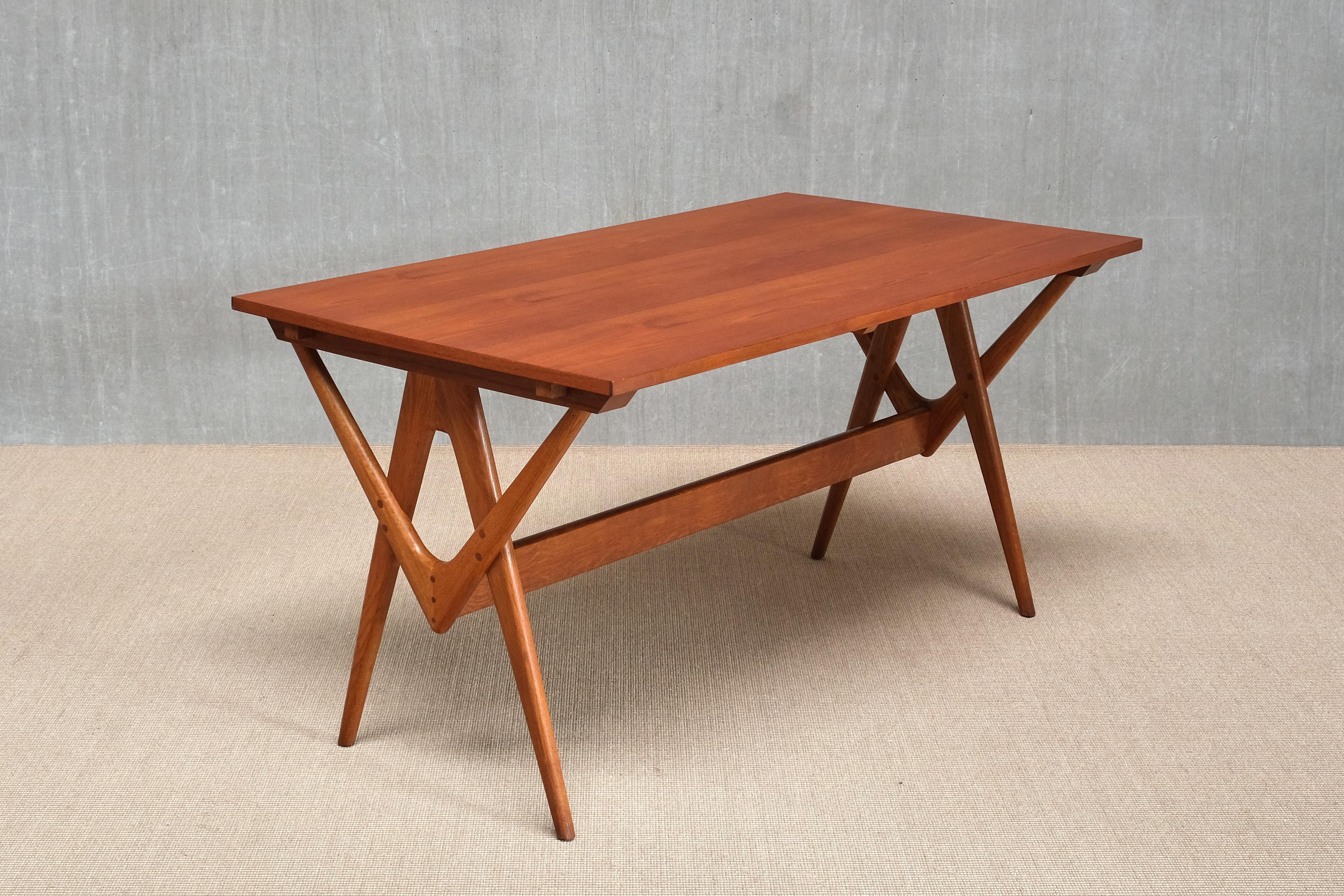 This exceptionally rare dining table was designed by Knud Mortensen in 1955 and crafted by master cabinetmaker Søren Horn in Denmark. First presented at the Copenhagen Cabinetmakers’ Guild Exhibition that same year, it is believed that very few