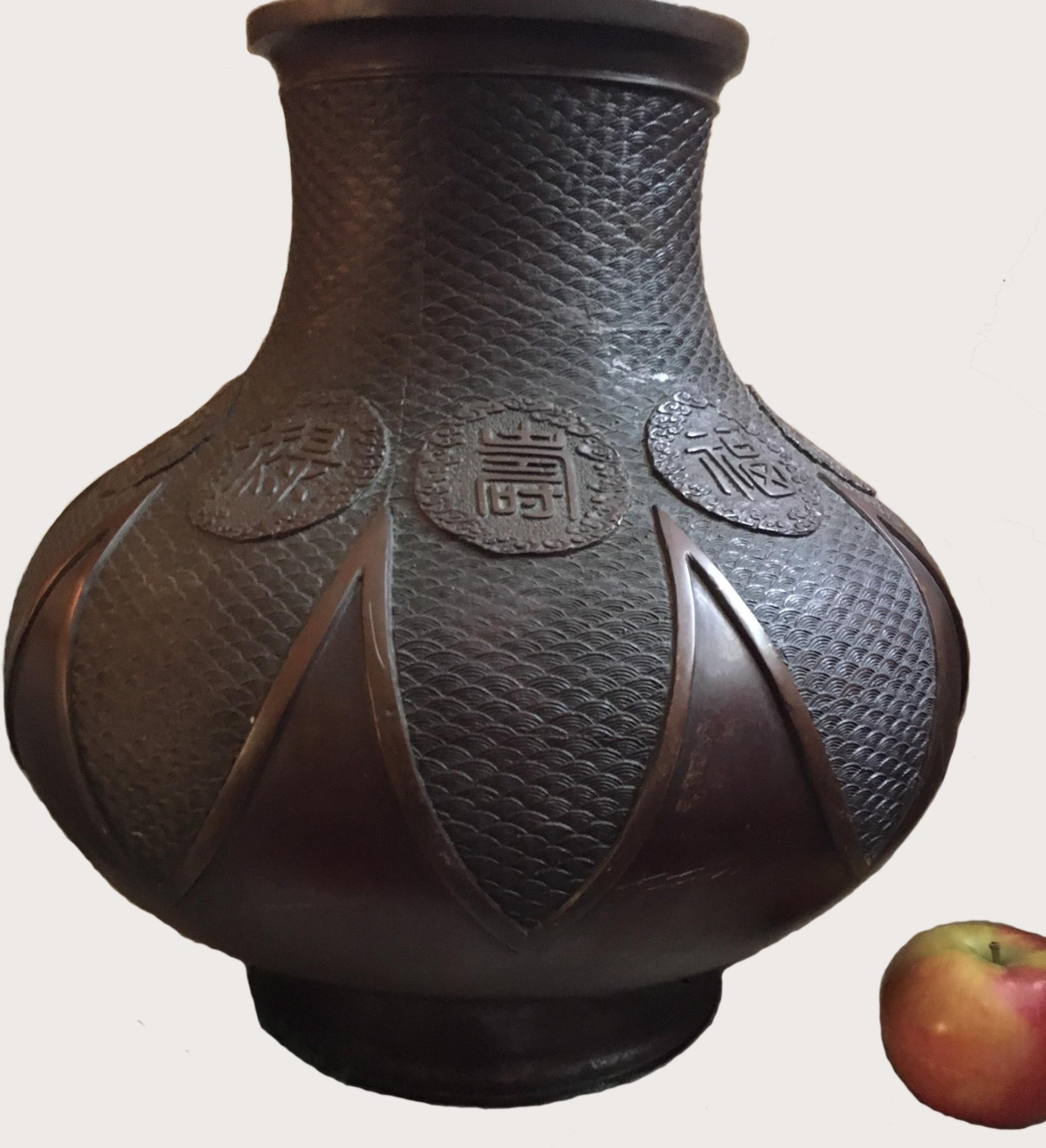 The pear shaped body is rising from the short splayed foot to a waisted neck and flared mouth. The excellent, masterfully casted bronze is decorated with the finest seigaiha pattern. Rich warm brown patina completes the beauty of this Chinese style