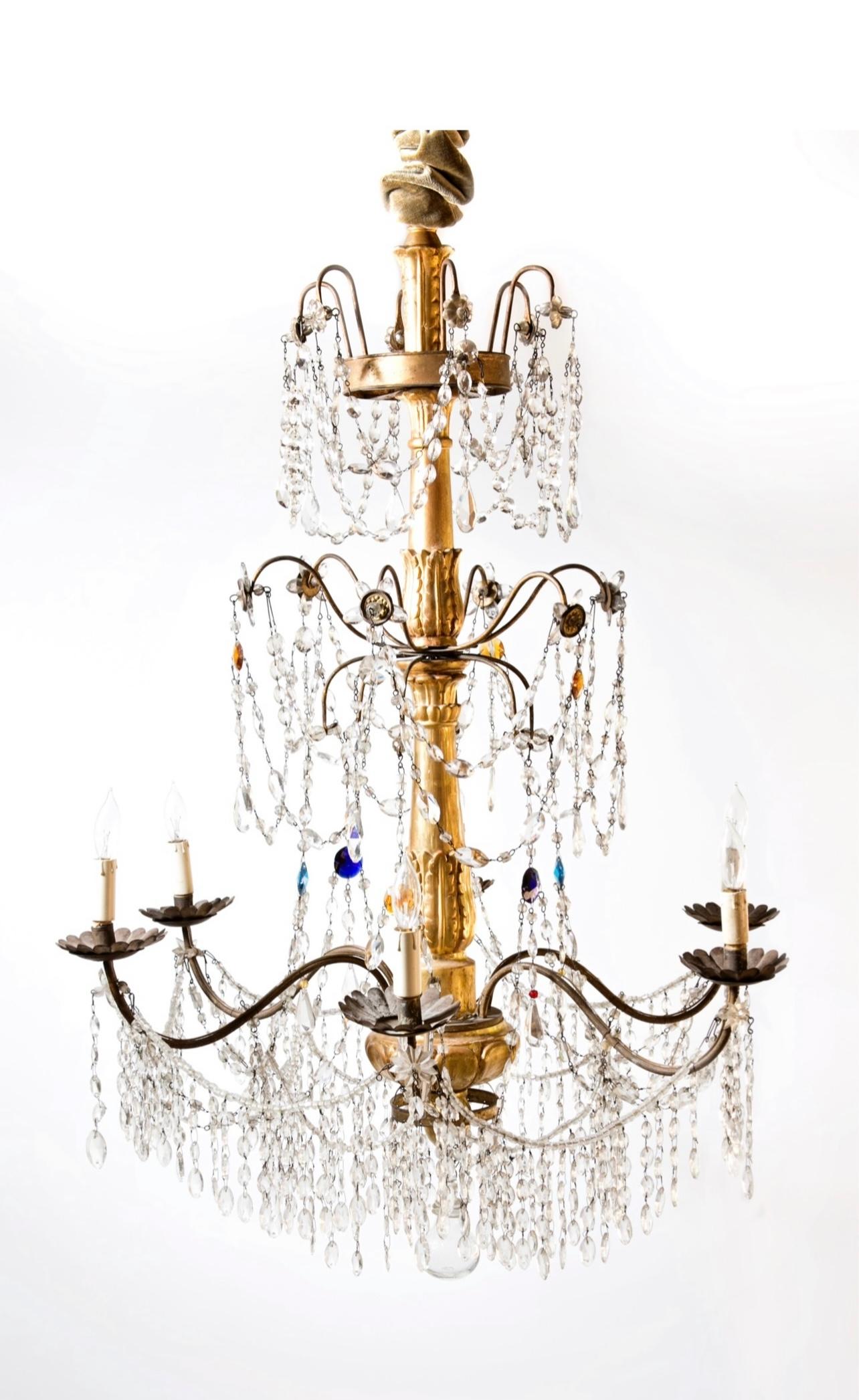 A beautiful and elegant  Italian 18th century Genovese gilt, colored glass and crystal
chandeliers. This is One of Two of a Pair.  Available as a pair as well The six scrolled gilt iron electrified arms are beautifully decorated with swaging crystal