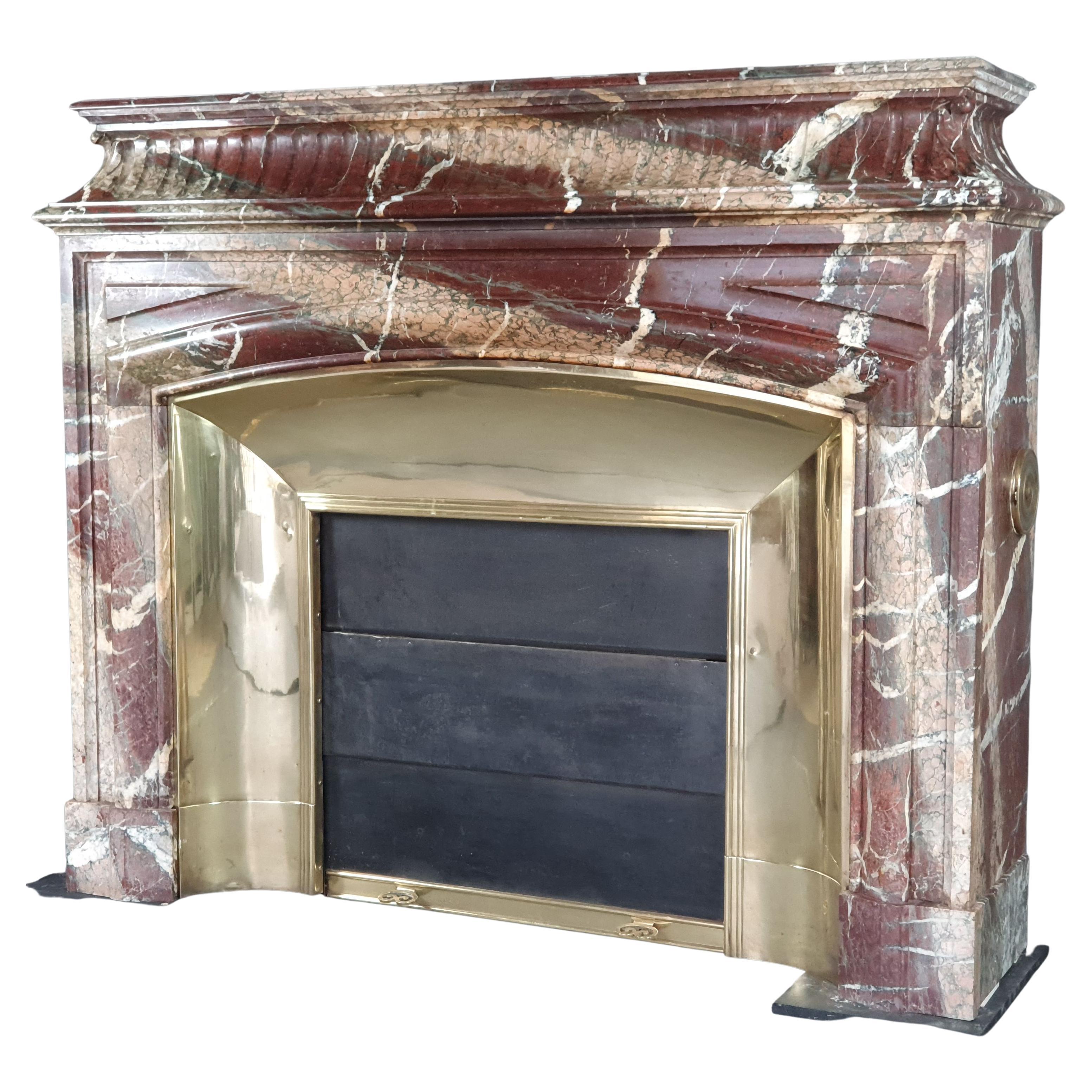 Important Louis XIV Fireplace With Acroterion In Campan Grand Mélange Marble For Sale