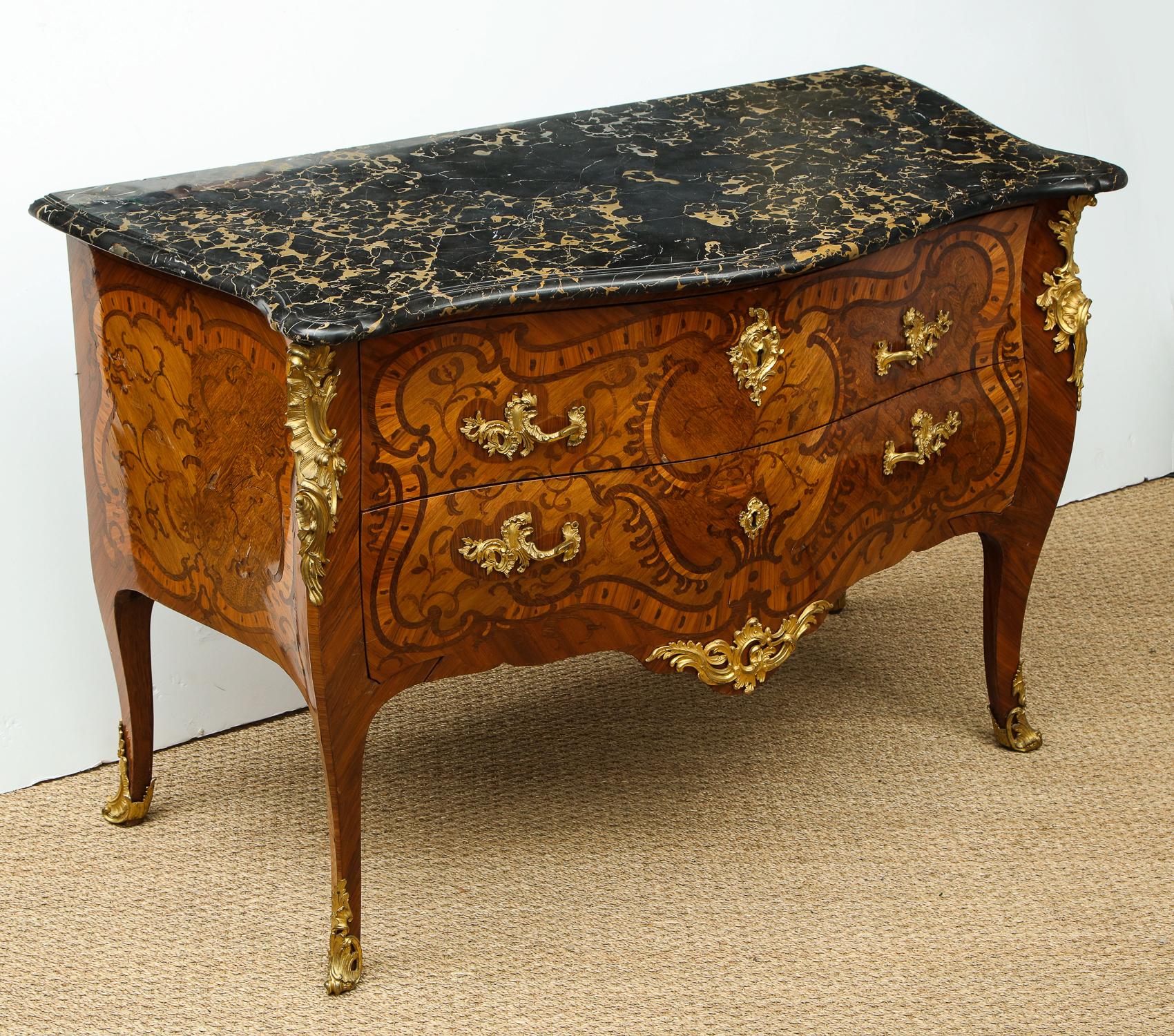 Important Louis XV inlaid kingwood commode by Pierre II Migeon, circa 1745, having original shaped and molded Porto marble top over two drawers having high style rocaille inlay and original gilt bronze mounts,
 
Important Louis XV ormolu-mounted