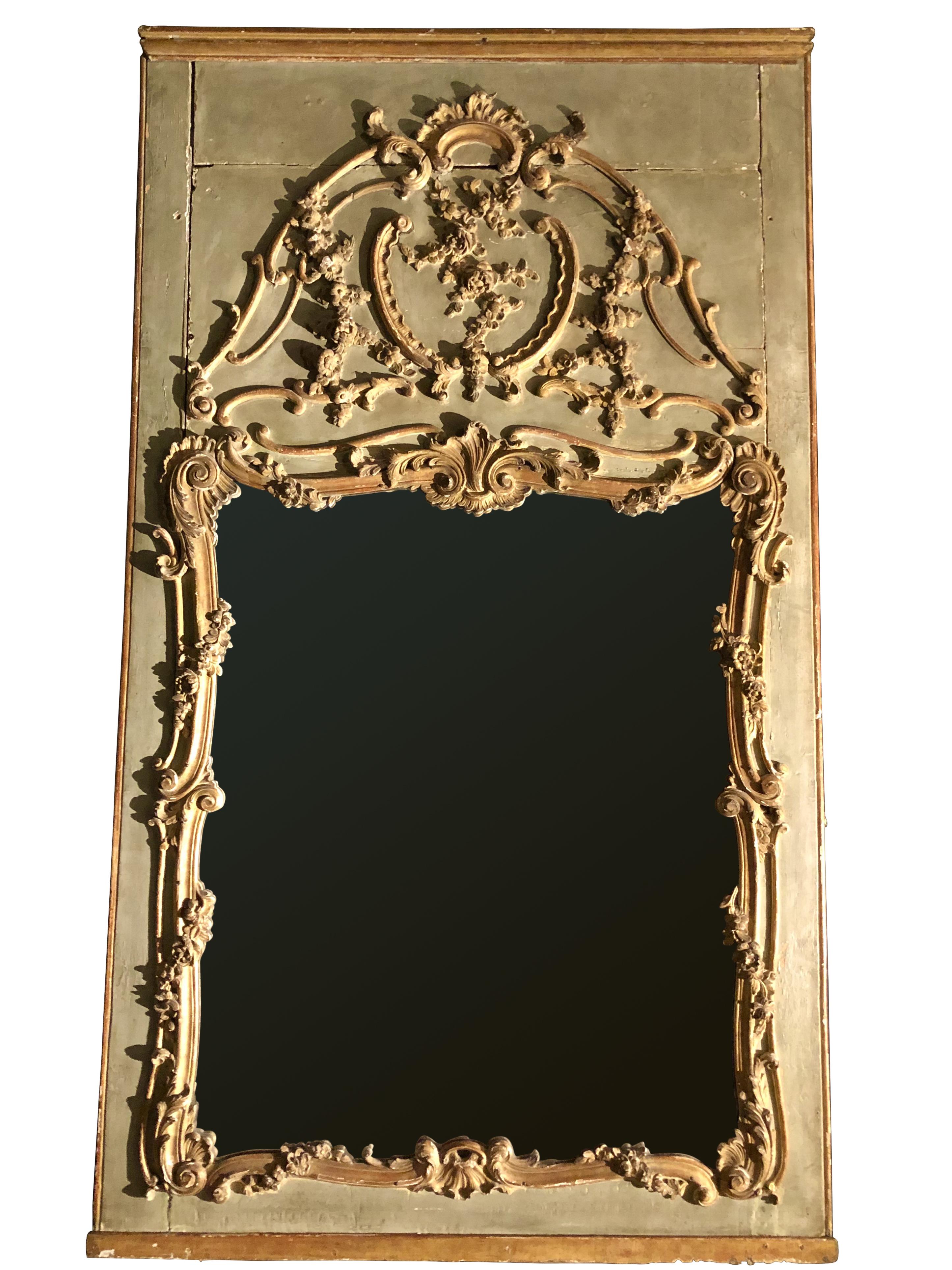 Elegant wooden trumeau in water green and gilded lacquered wood, carved with shells, foliage, garlands. Original mercury mirror.
Parisian work
France
18th century.
