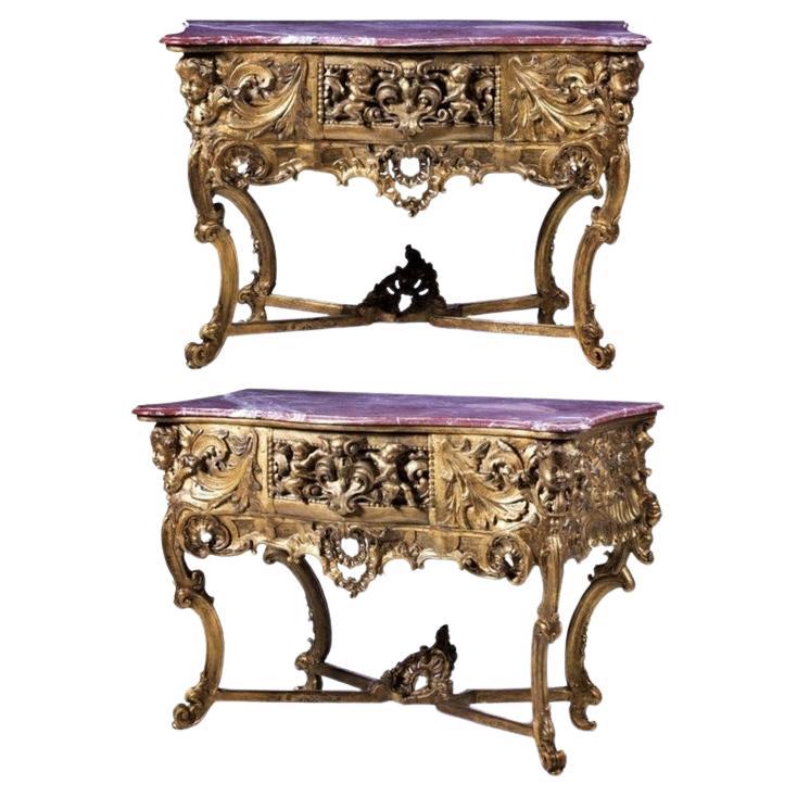 Great mobile (Credential)
Portuguese 18th century
in carved, pierced and gilded wood with a drawer. Decorated with angels, puttis and plant motifs, it rests on four curved legs ending in a winding, connected by an X beam. Top in pink marble. Flaws