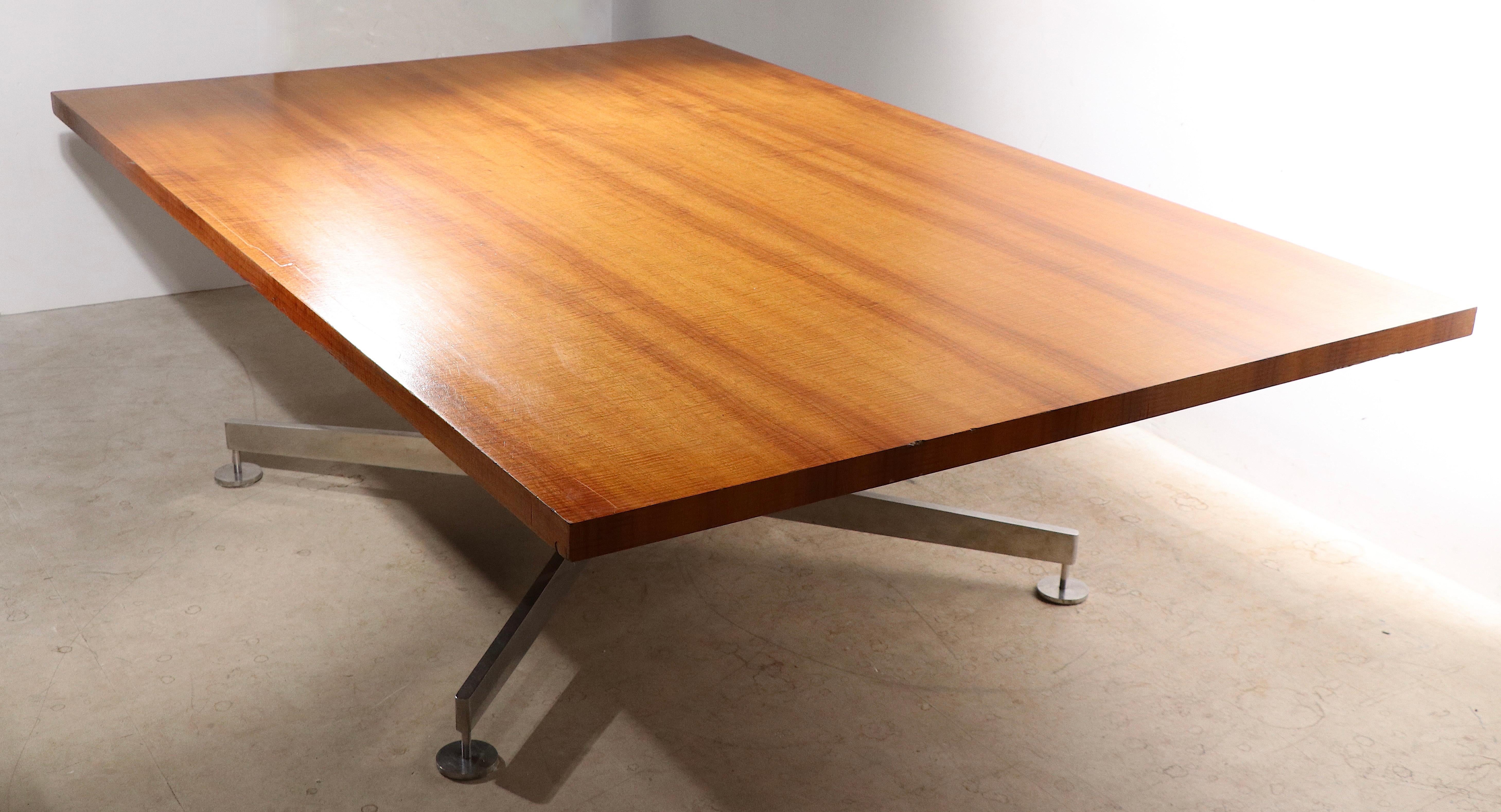 Spectacular large table, designed by Edward Wormley , Manufactured by Dunbar, having an X, or cross, form base, constructed of polished stainless steel, with screw in disk feet, and table mounts.  The tops  are constructed  of ( 2 )  wood planks (