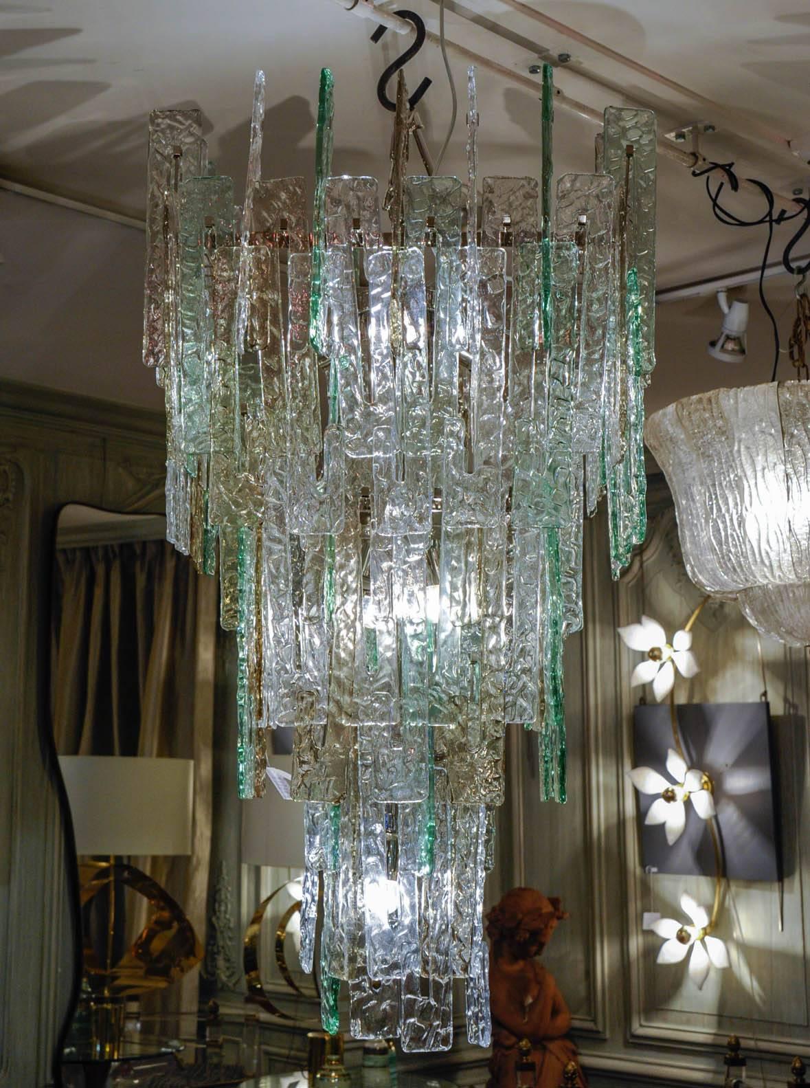 Important chandelier made of a fall of Murano glass tiles, transparent and celadon green colored. The chromed structure contains ten lamp bulbs. A pair is available.