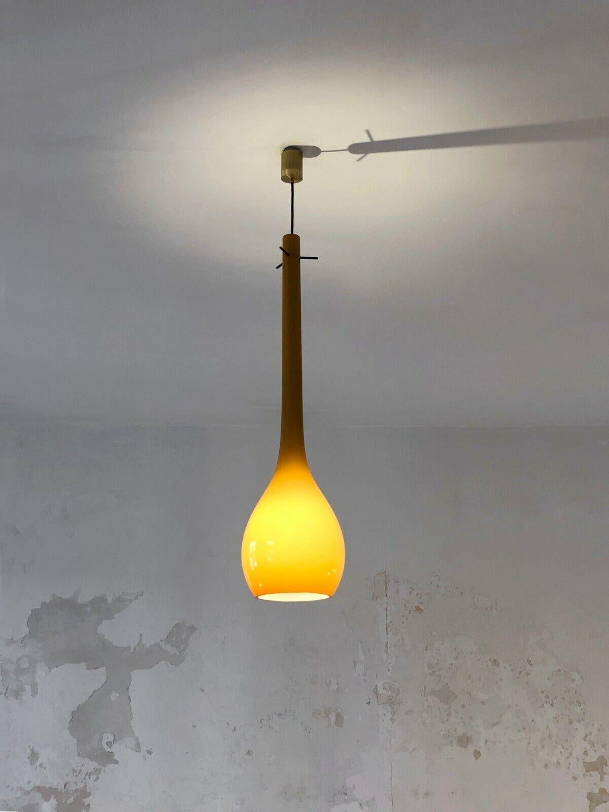 An exceptional long drop pendant light, Modernist, Free Form, Shabby-Chic, with a very fine design, in yellow ocher Murano glass fixed by 2 patinated brass cylinders, to be attributed, Murano, Italy 1960.

DIMENSIONS:
Height of glass alone: 80