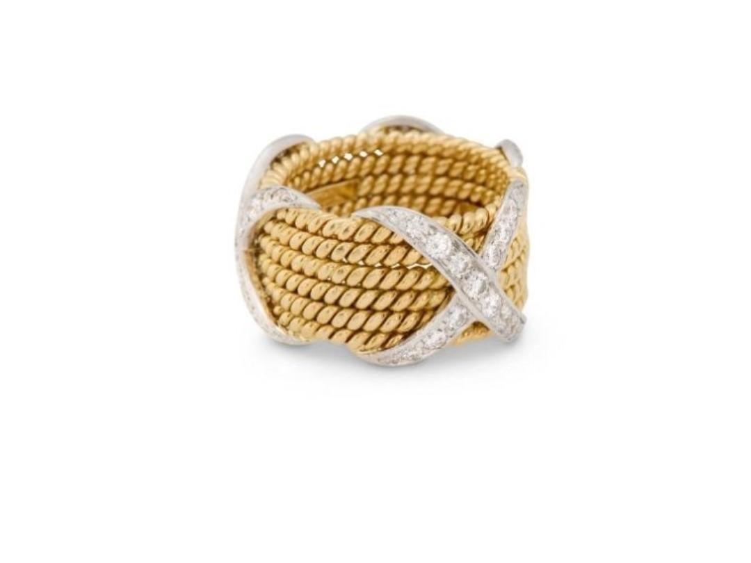 The Following Item we are offering is a Rare Important Original Platinum and 18KT Gold TIFFANY & CO., SCHLUMBERGER 18K Gold, Platinum, and Diamond 'X' Ring
the six rope gold bands spaced by three platinum 'X's set with full-cut diamond; signed