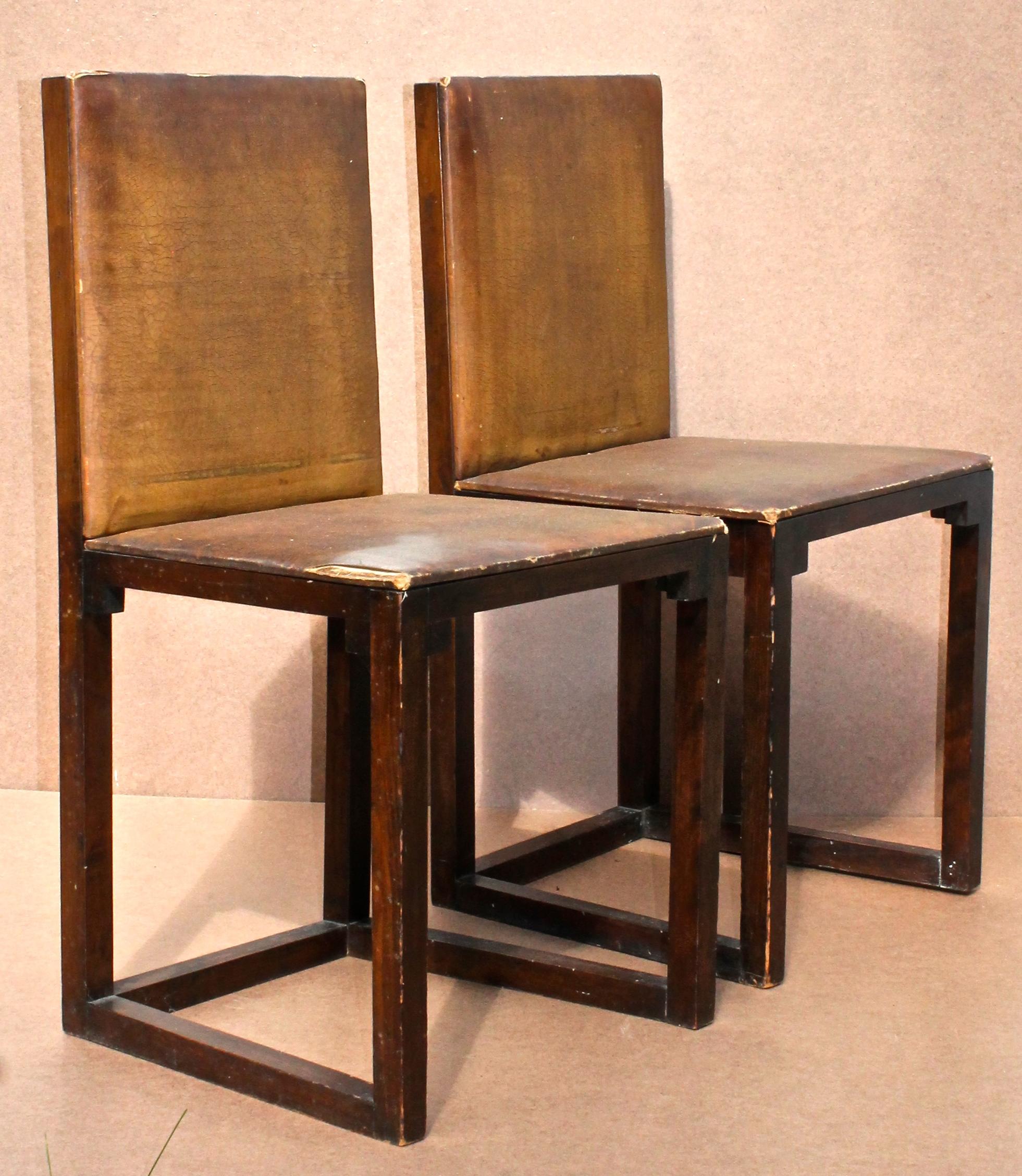 A rare and important pair of rationally designed square section wood chairs with 'oilcloth' upholstered seats/backs. The handling of the corner structure with small cubes is an especially innovative solution.