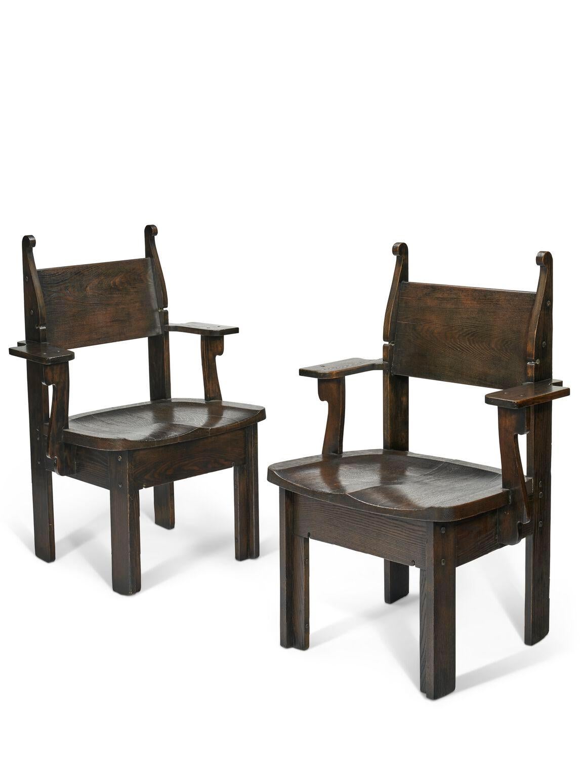 This very rare and highly collectible pair of stained oak armchairs by Charles Rohlfs (1853–1936) featuring saddle seats and faceted pegs. Both chairs are signed with his cypher mark and dated 1904, interestingly, one chair has two cypher