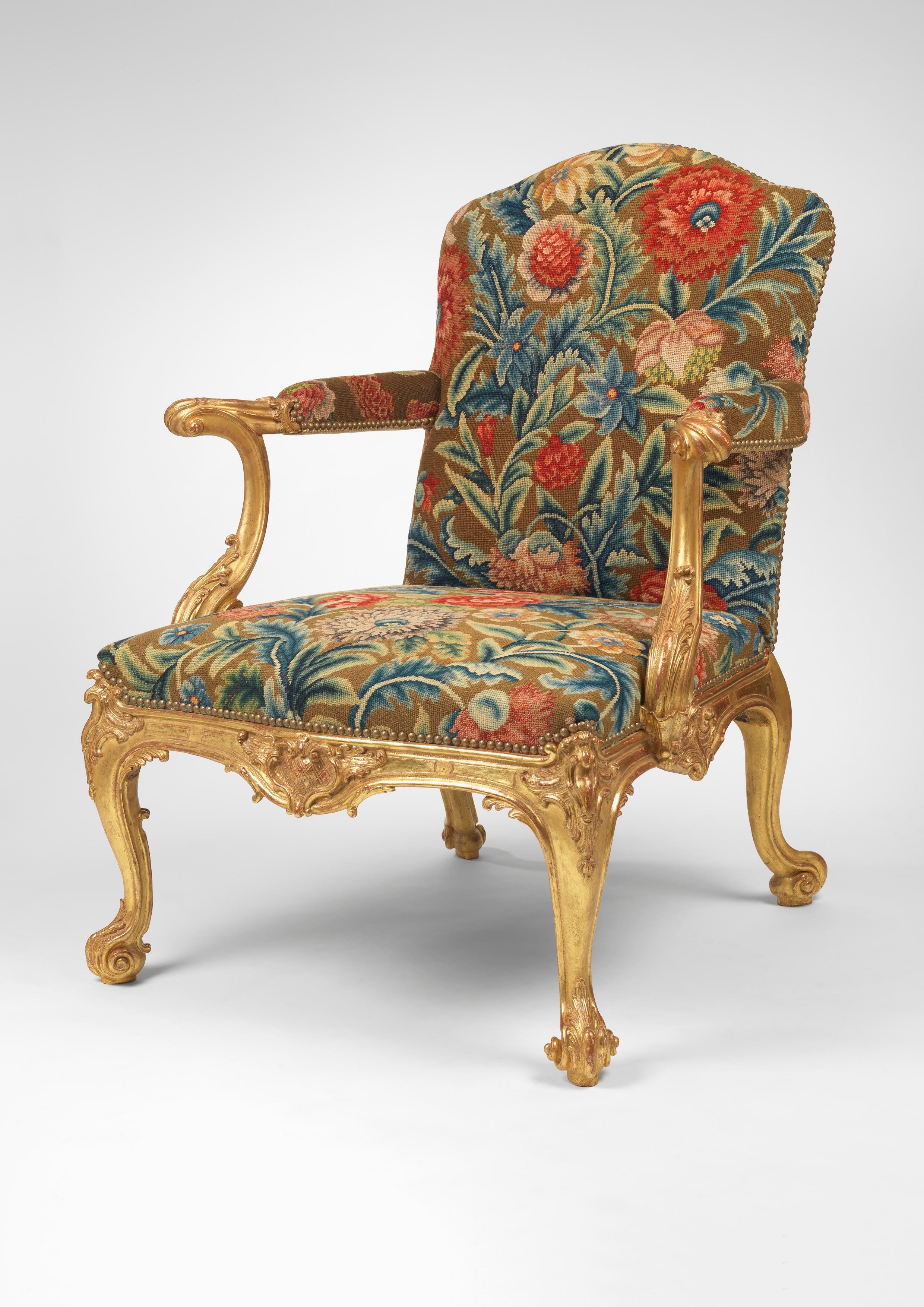 An Important Pair of George II giltwood armchairs in the manner of Thomas Chippendale upholstered in associated 18th century needlework.

The serpentine shaped upholstered backs to elaborate out-scrolling open arms, with serpentine shaped seat