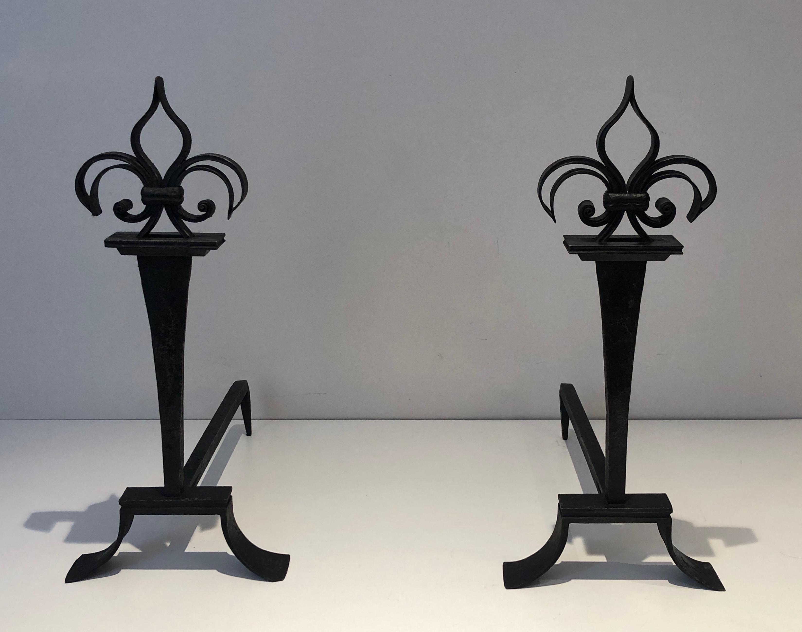 This important pair of andirons is made of wrought iron with a Lily flower on top. This is a Fine iron work. French. Circa 1950