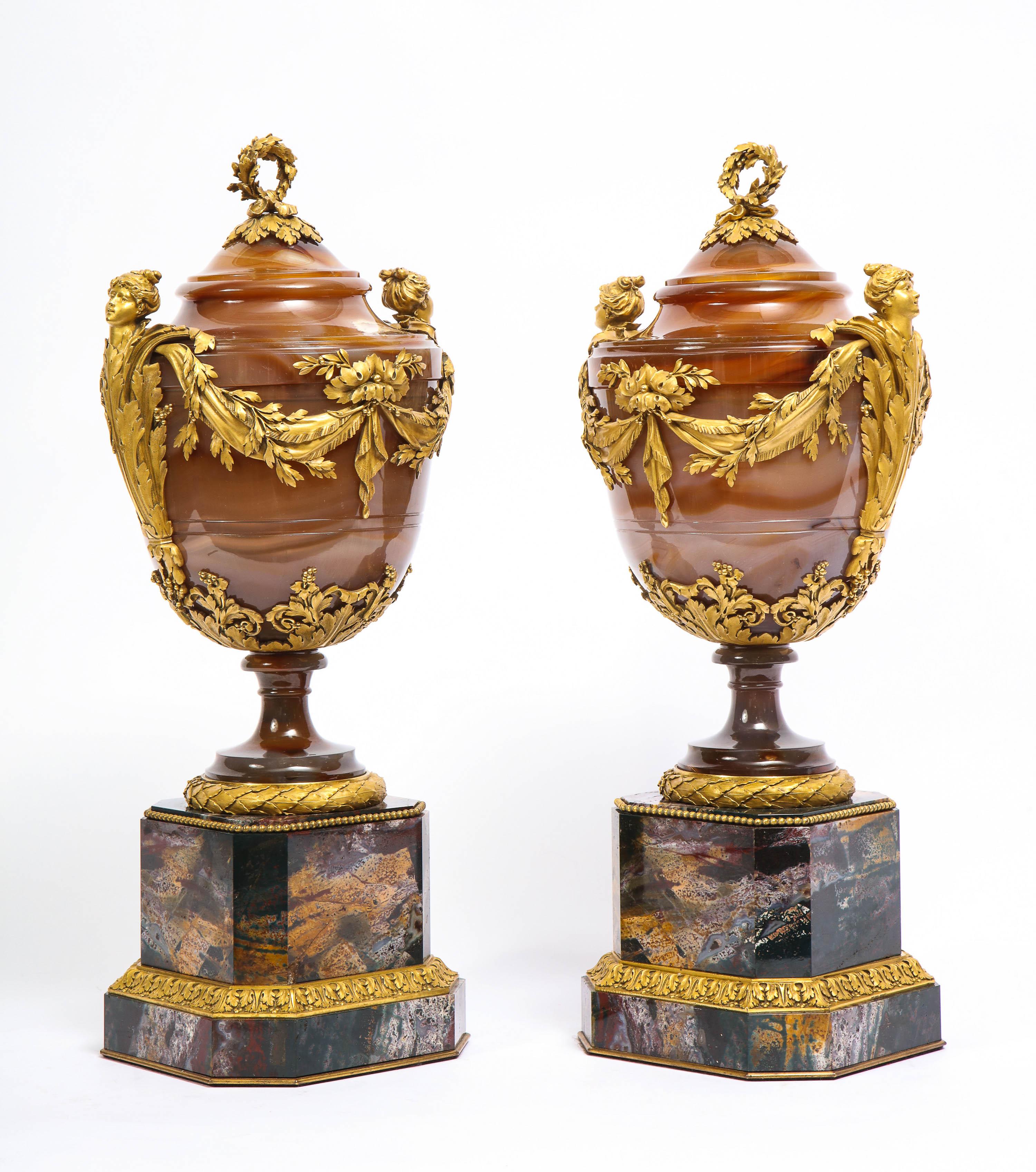 A magnificent and highly important pair of Russian Imperial Louis XVI style agate and bloodstone ormolu-mounted Jasper vases with agate and ormolu wreath finial covers. Both vases are of tapered ovoid form and mounted on the center of each body are