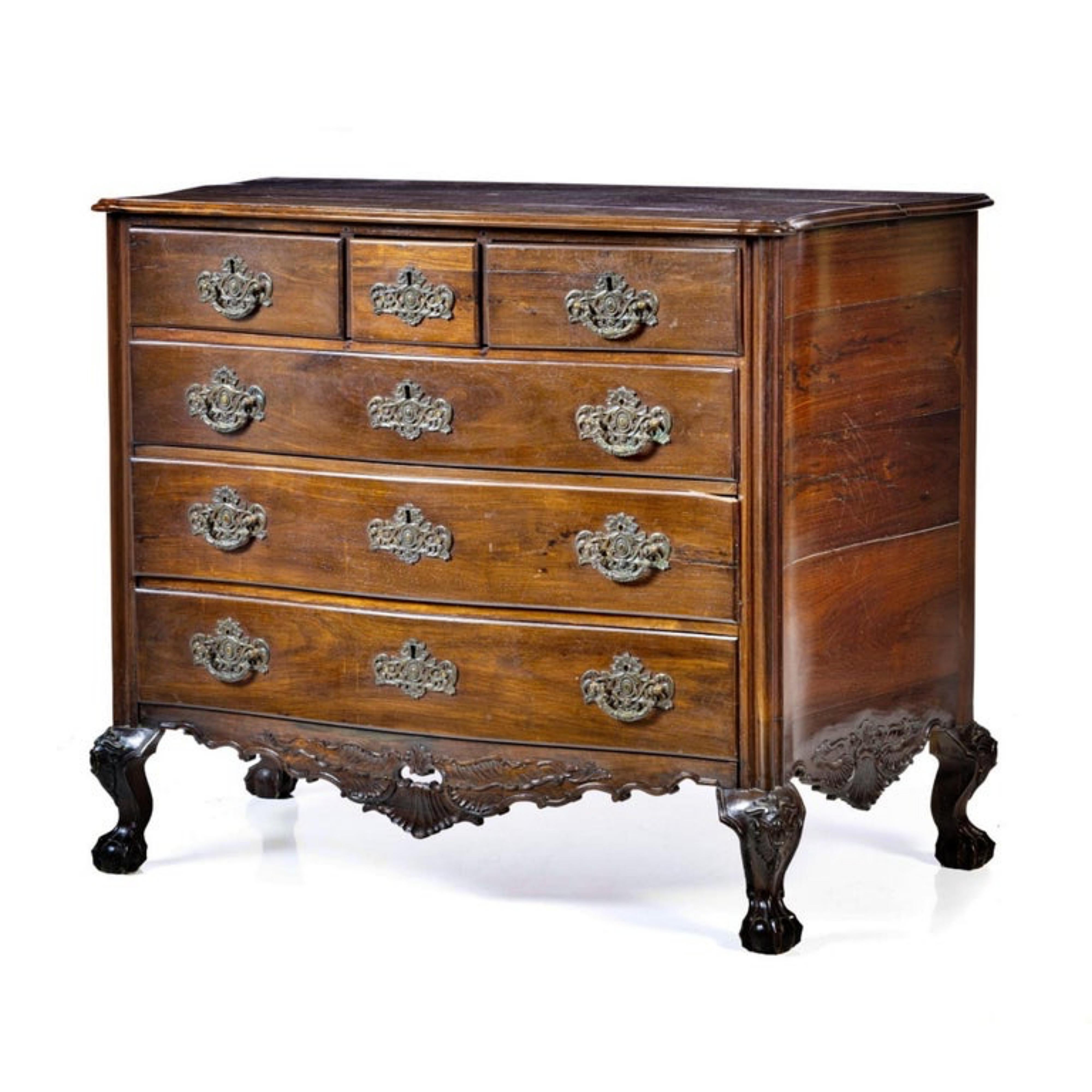 IMPORTANTE COMMODE PORTUGAISE D. V.I.I. XVIIIe siècle
 
en bois de rose, avec trois tiroirs et trois grands tiroirs.
Corps ondulé, avec jupes coupées, décoré de coquillages, d'enroulements et de motifs végétaux.
Les pieds sont incurvés et reposent