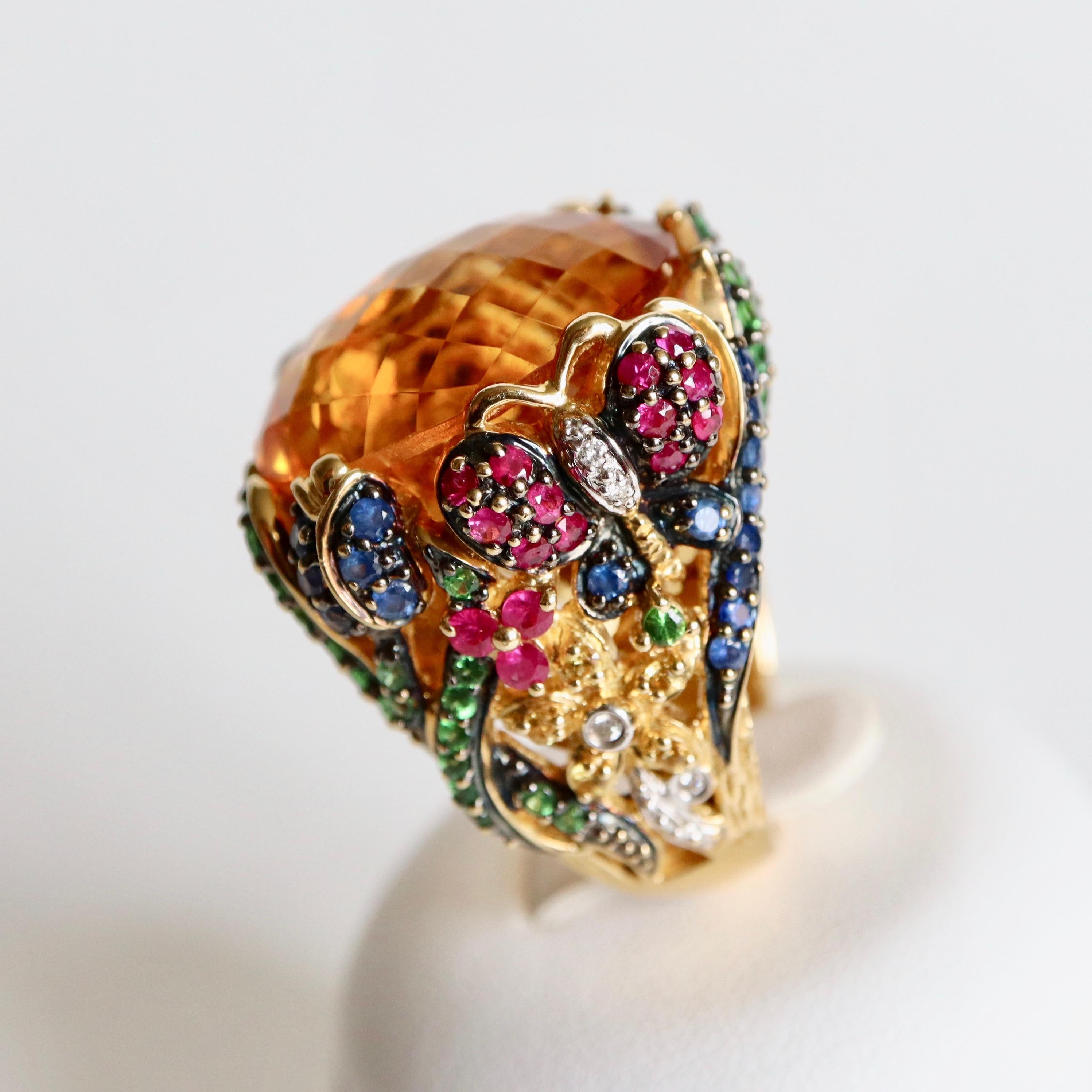 Important Ring with Foliage Pattern and Intertwined Flowers in 18 Carat yellow Gold setting a Large Faceted Oval Citrine Size 16 x 22 mm, the Openwork Body is Decorated with Sapphires, Rubies, yellow Sapphires, Tsavorite Garnets and Diamonds
Ring
